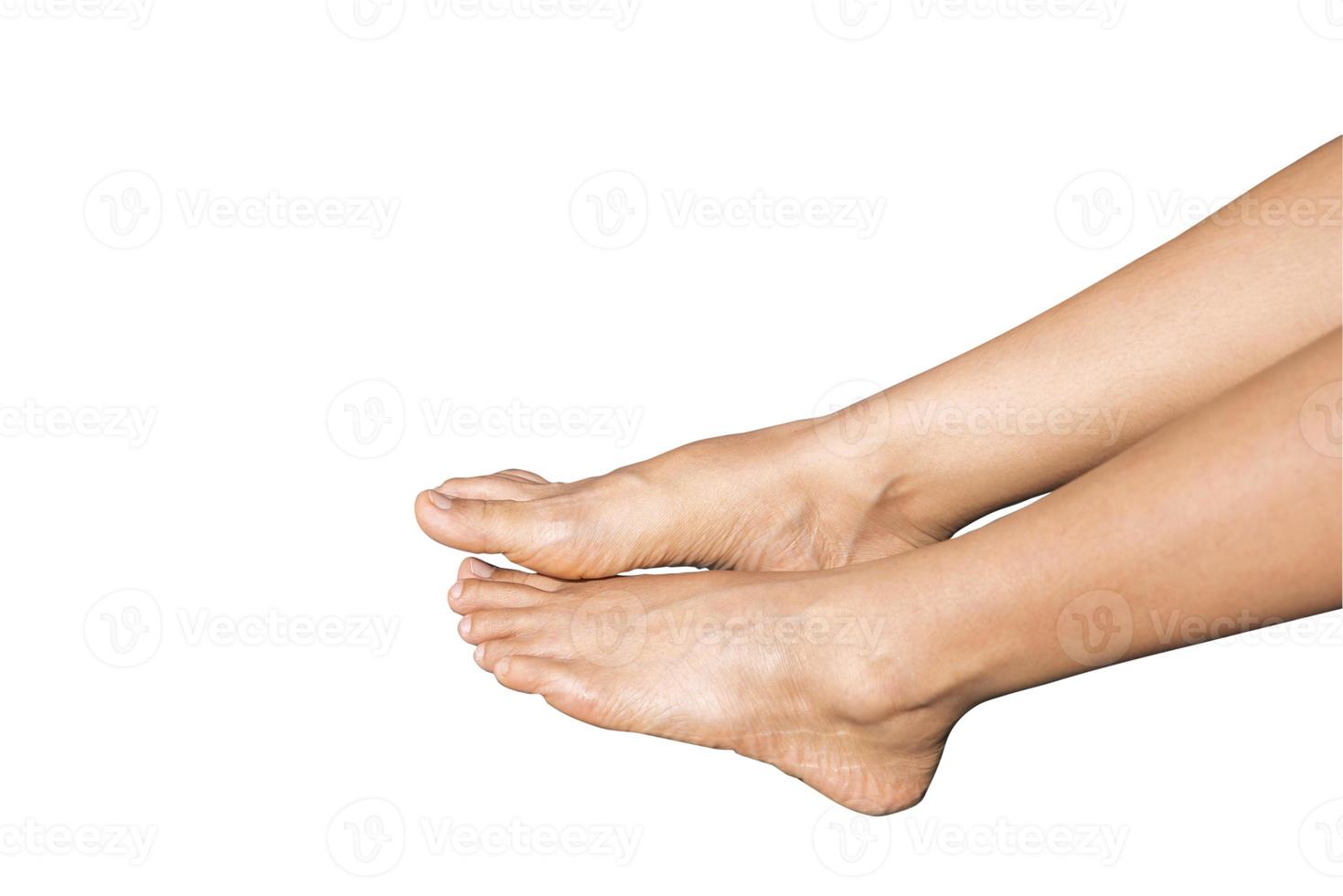 Beautiful clean woman's feet above water at swimming pool isolated on white background. Beautiful and elegant groomed girl's touching her foot. concept about Spa ,travel and skin care photo