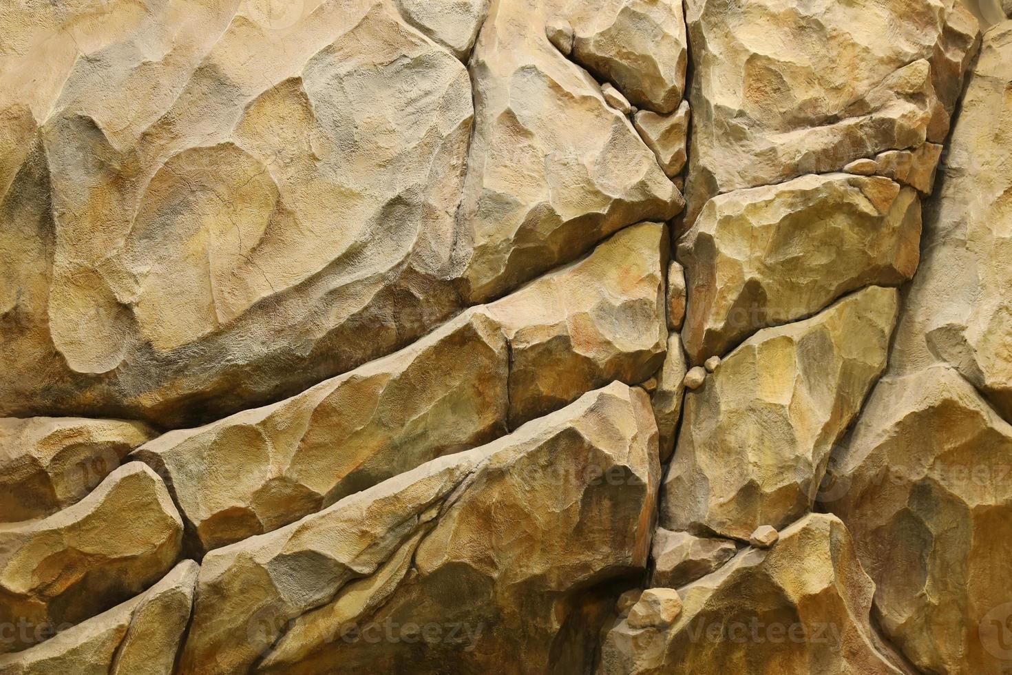 Light coarse natural rock stone background. Mining cliff rough front surface. Big limestone stack backdrop. Heavy grunge damaged granite block texture photo