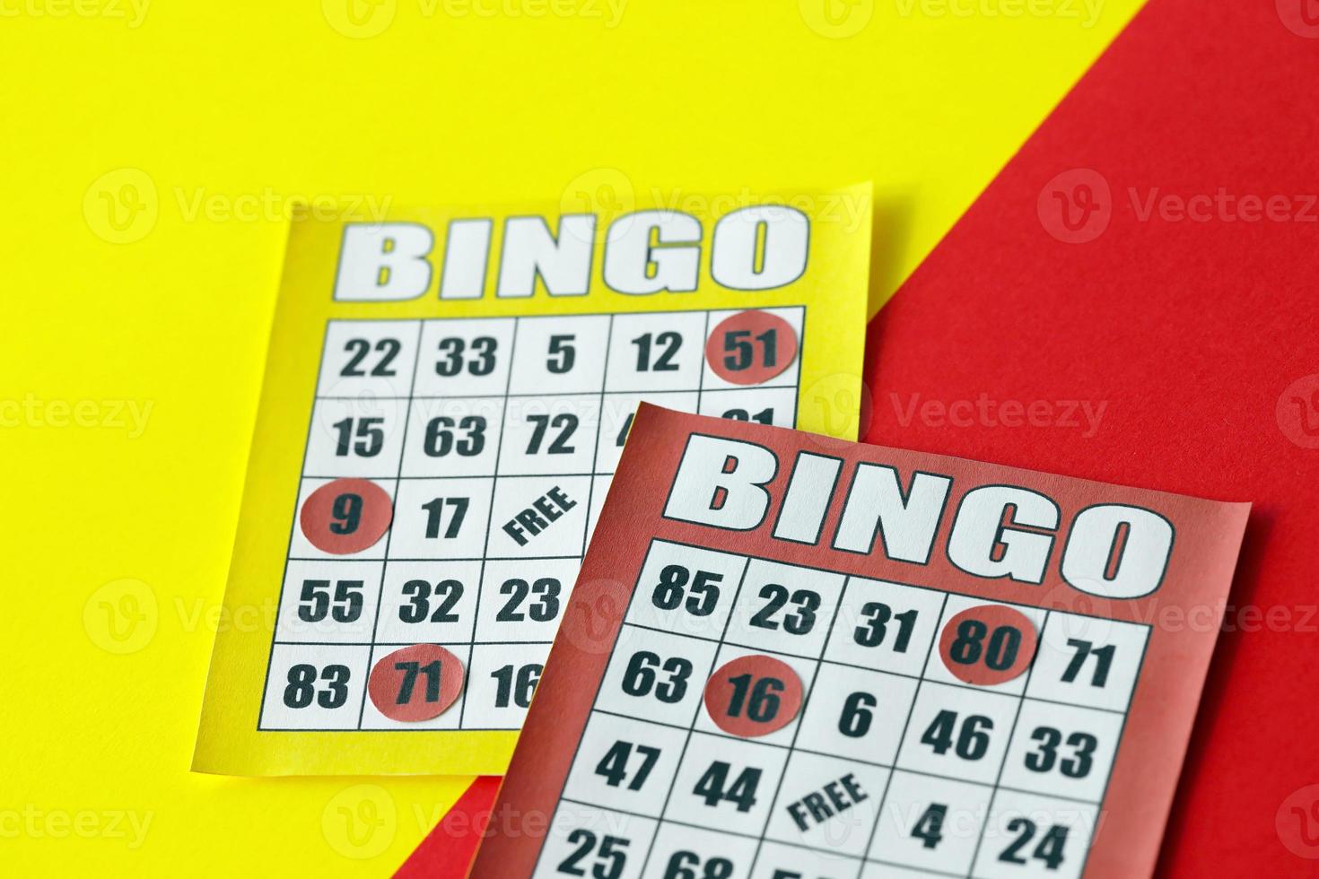 Yellow and red bingo boards or playing cards for winning chips. Classic US or canadian five to five bingo cards on bright background photo