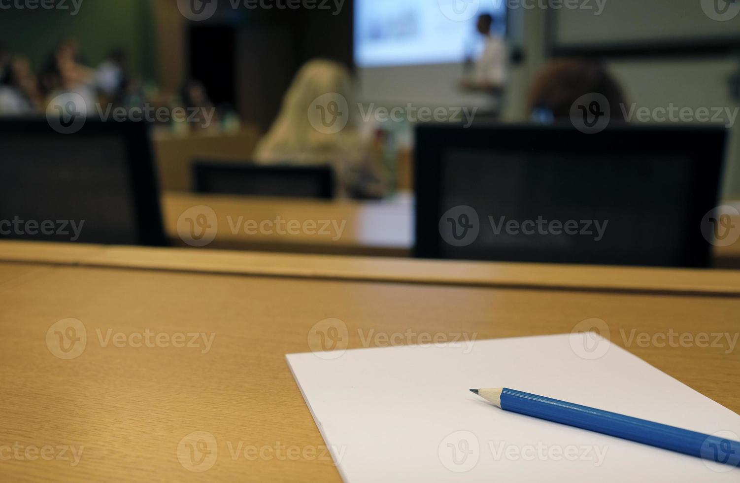 During a lecture or presentation - pen and paper in an auditorium photo