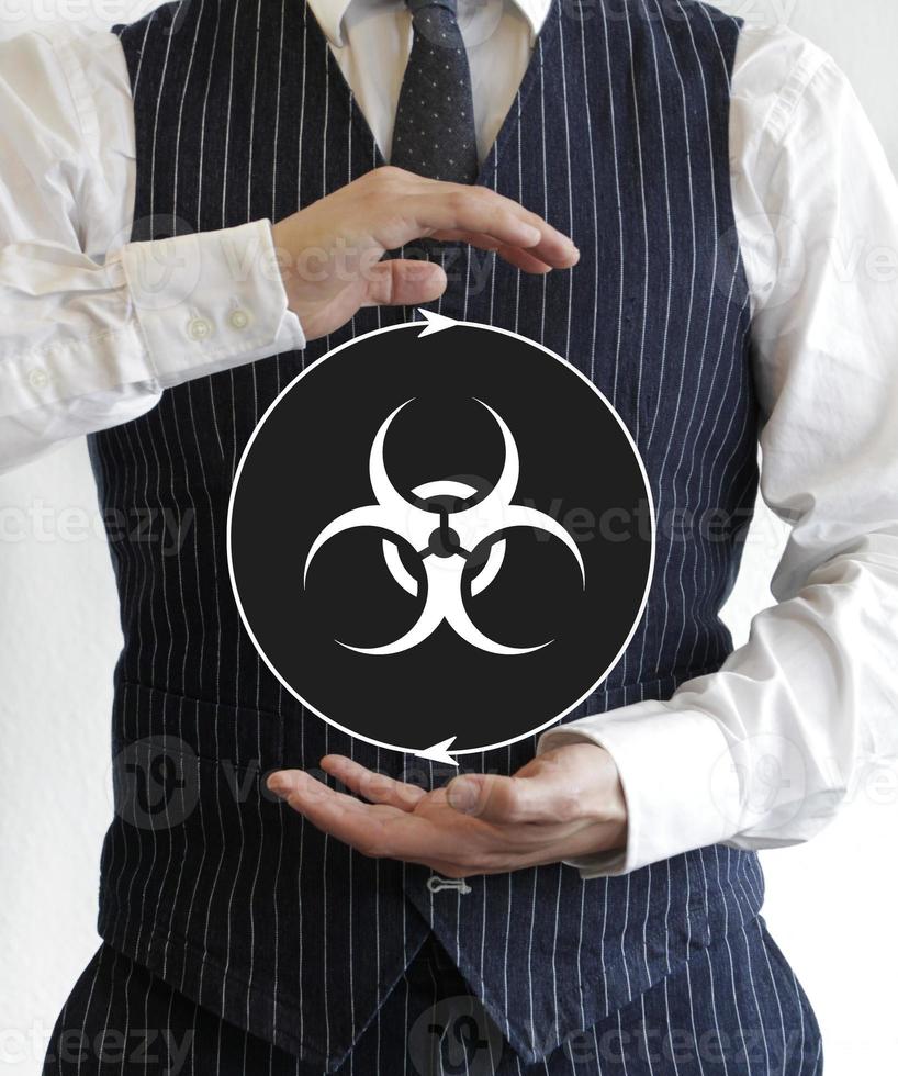 Man holding a sign with bio hazard symbol photo