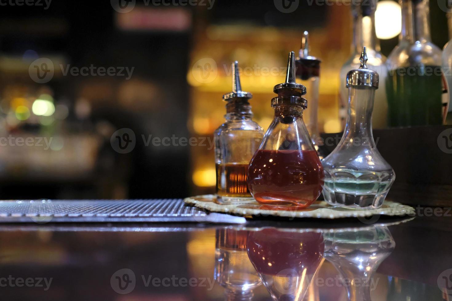 Colorful flasks on a cocktail bar counter 11108079 Stock Photo at Vecteezy