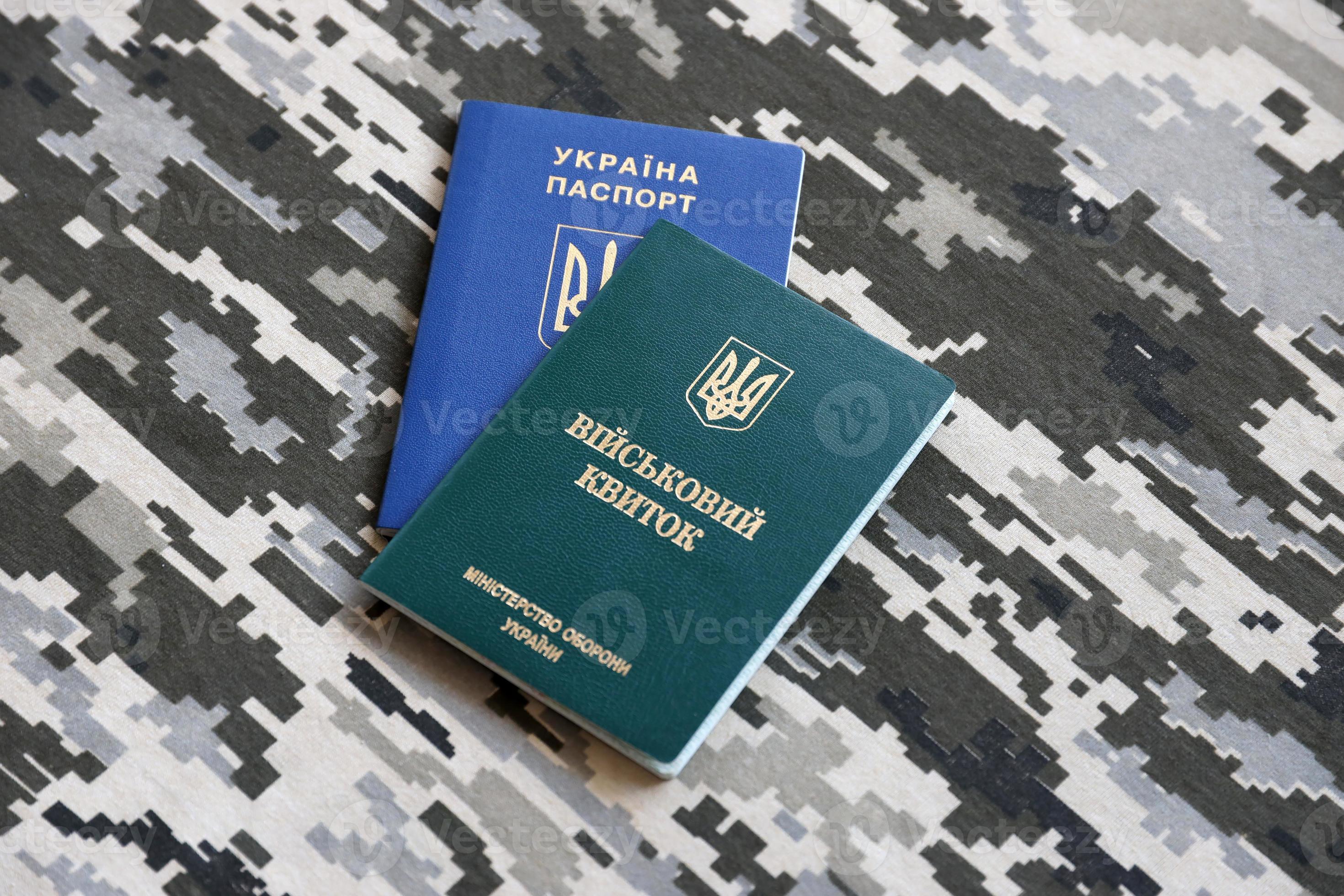 Ukrainian military ID and foreign passport on fabric with texture of