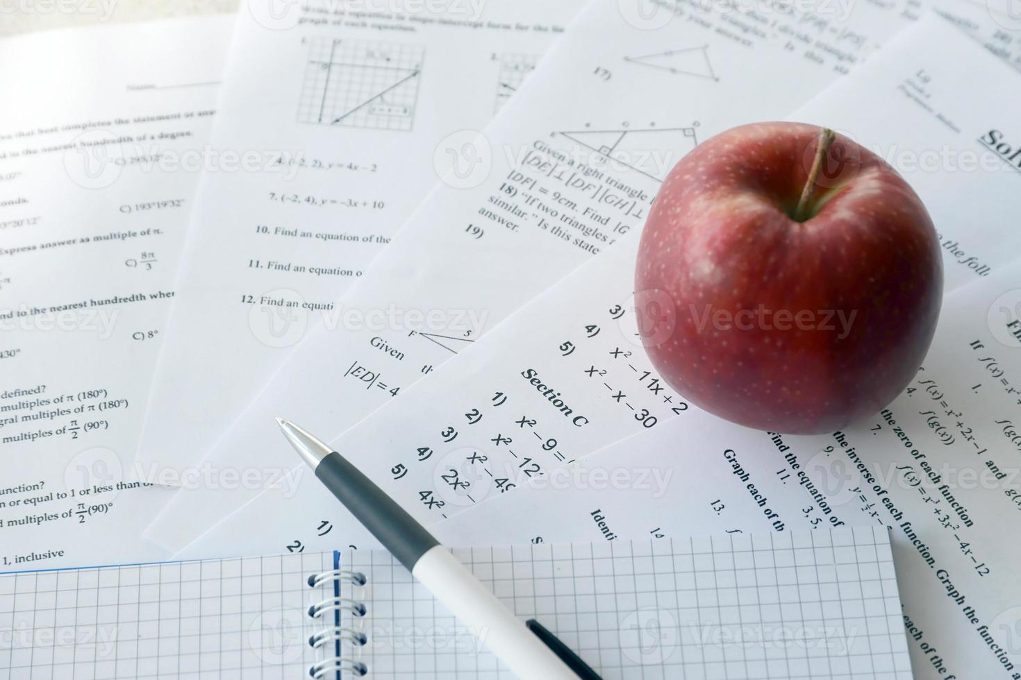 Handwriting of mathematics quadratic equation on examination, practice, quiz or test in maths class. Solving exponential equations concept. photo