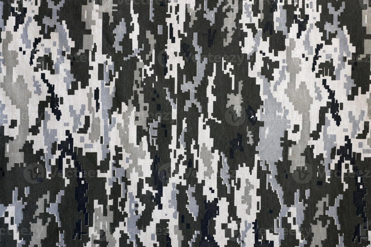 Fabric with texture of Ukrainian military pixeled camouflage. Cloth with camo pattern in grey, brown and green pixel shapes. Official uniform of Ukrainian soldiers photo