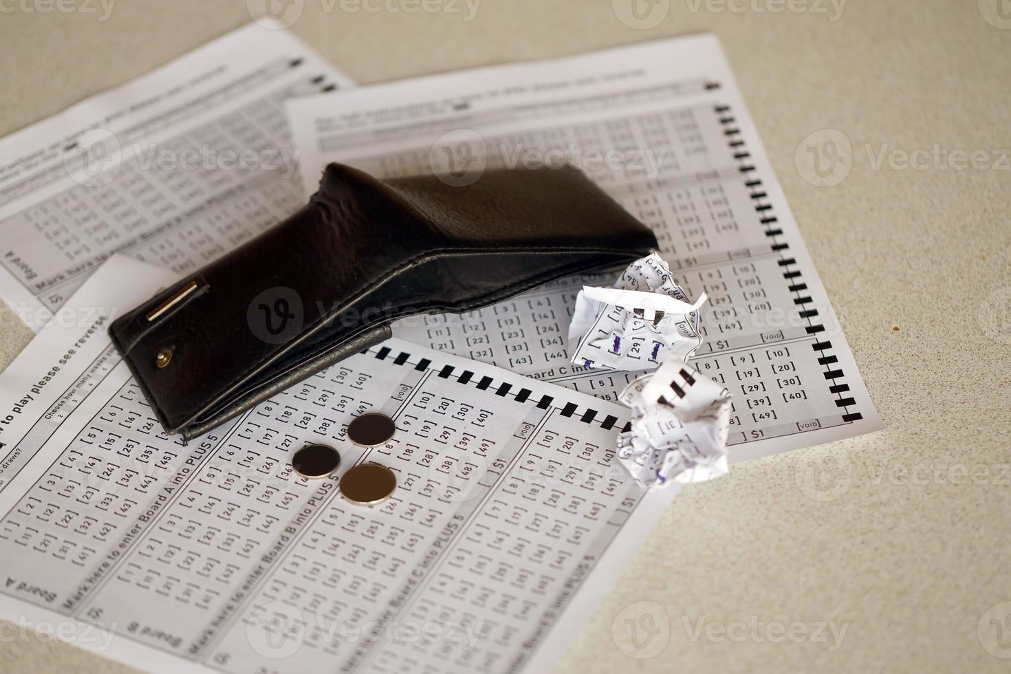 Crumpled lottery tickets and empty purse as symbol of losing the lottery game. Unlucky gambling results. Misfortune photo