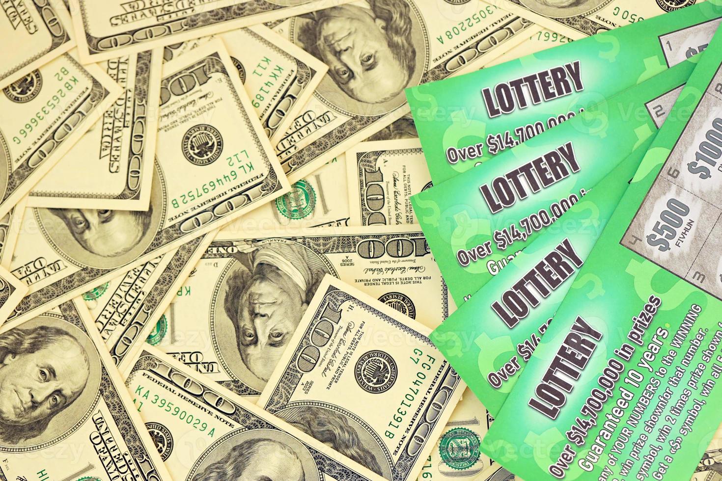 Close up view of green lottery scratch cards and us dollar bills. Many used fake instant lottery tickets with gambling results. Gambling addiction photo