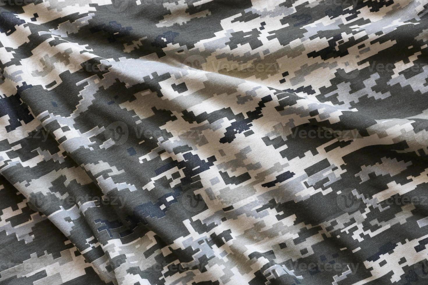 Fabric with texture of Ukrainian military pixeled camouflage. Cloth with camo pattern in grey, brown and green pixel shapes. Official uniform of Ukrainian soldiers photo