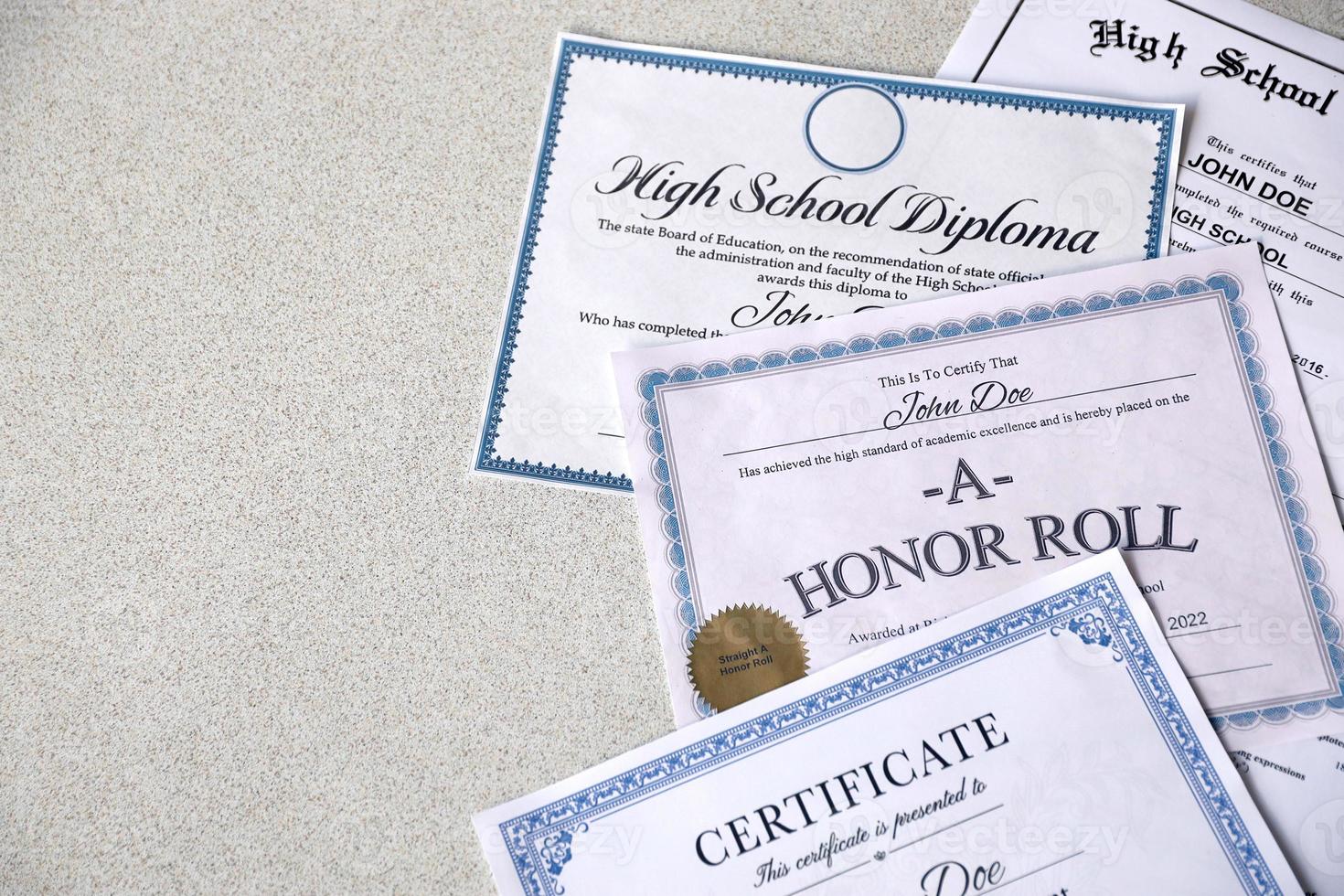 sobre la mesa hay un reconocimiento del cuadro de honor, un certificado de logros y un diploma de escuela secundaria. documentos educativos foto