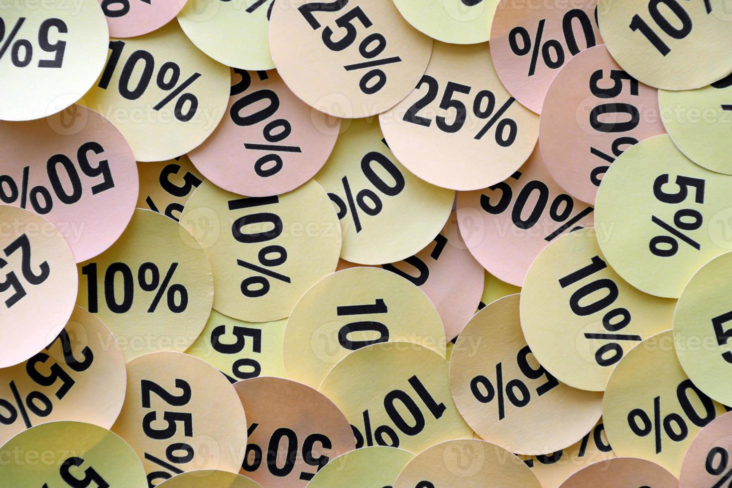 Large amount of stickers with yellow percentage values for black friday or cyber monday sale. Abstract image of discount prices photo