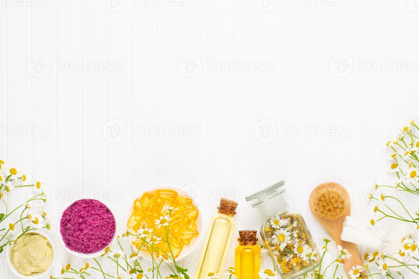 Spa still life with homemade cosmetic chamomile, herbal oil, soap, sea salt. photo