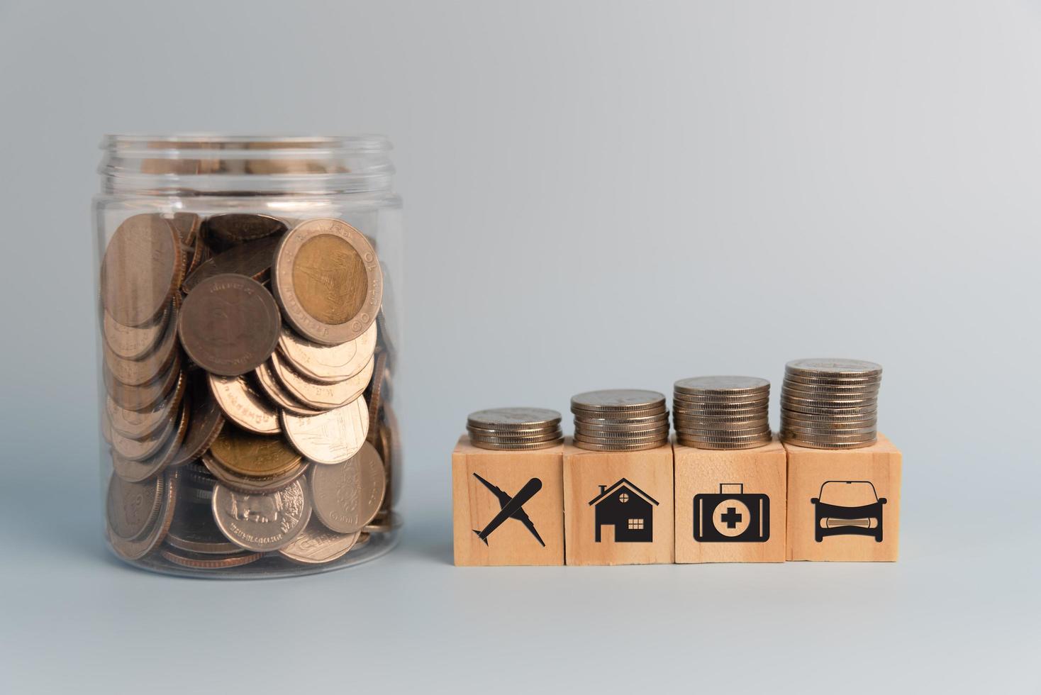 coin and wood cube block icon insurance assessment on table.Business finance investment saving money economy growth success concept. photo