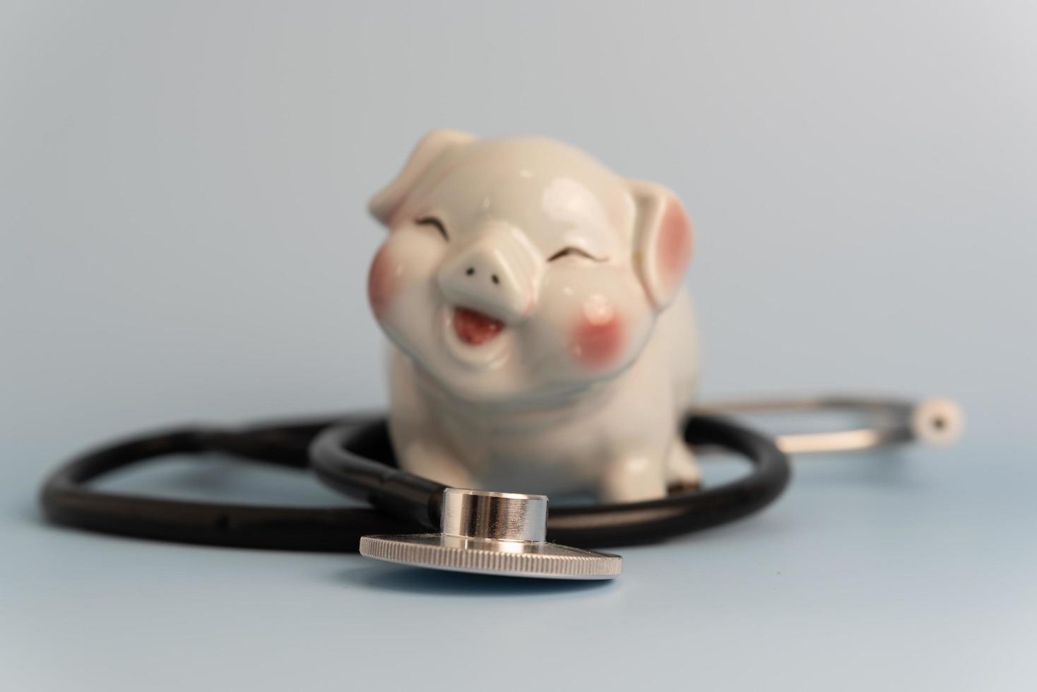 medical stethoscope piggy bank business concept insurance investment health care and saving money. photo