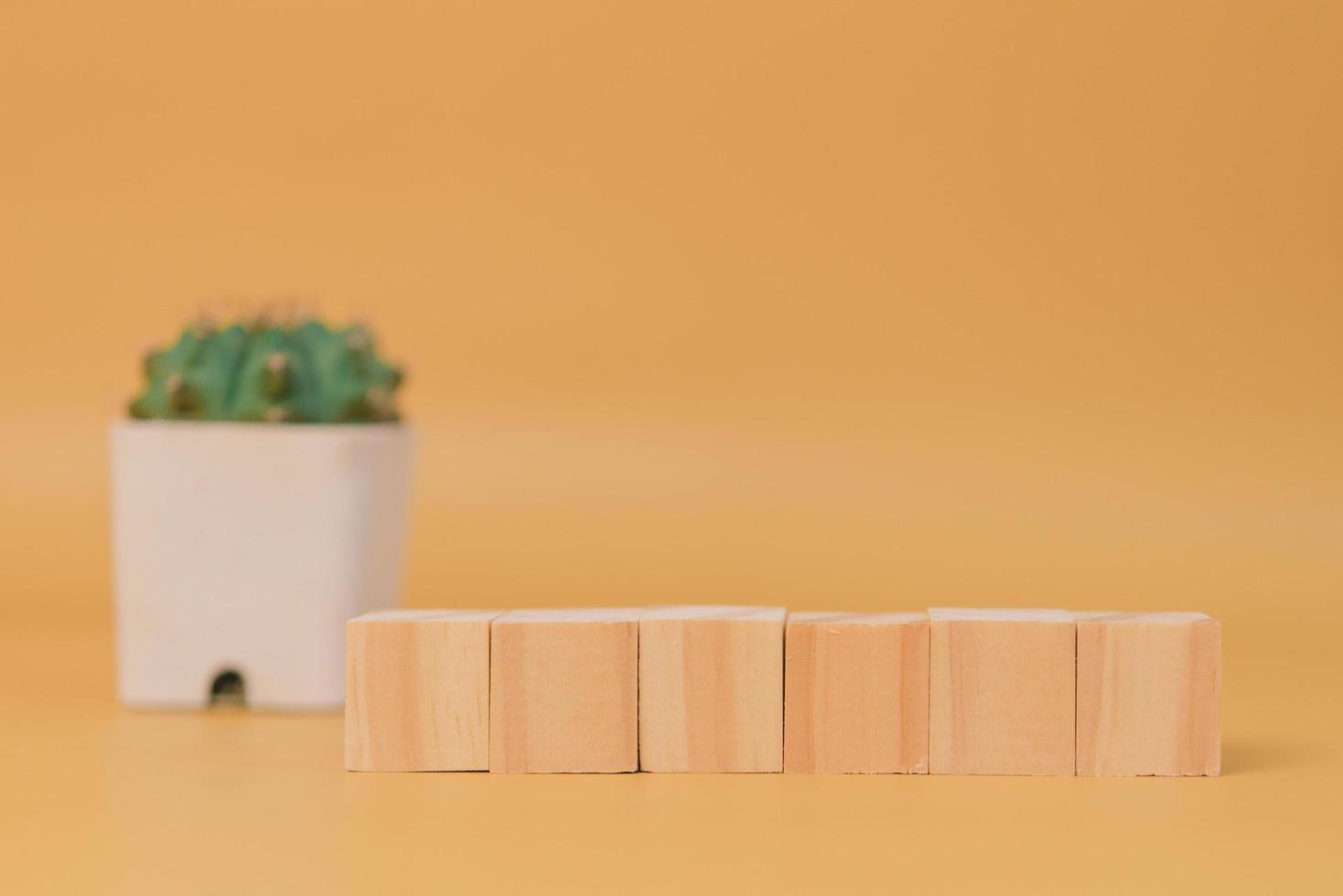 wood cube block blank and tree on yellow background. photo