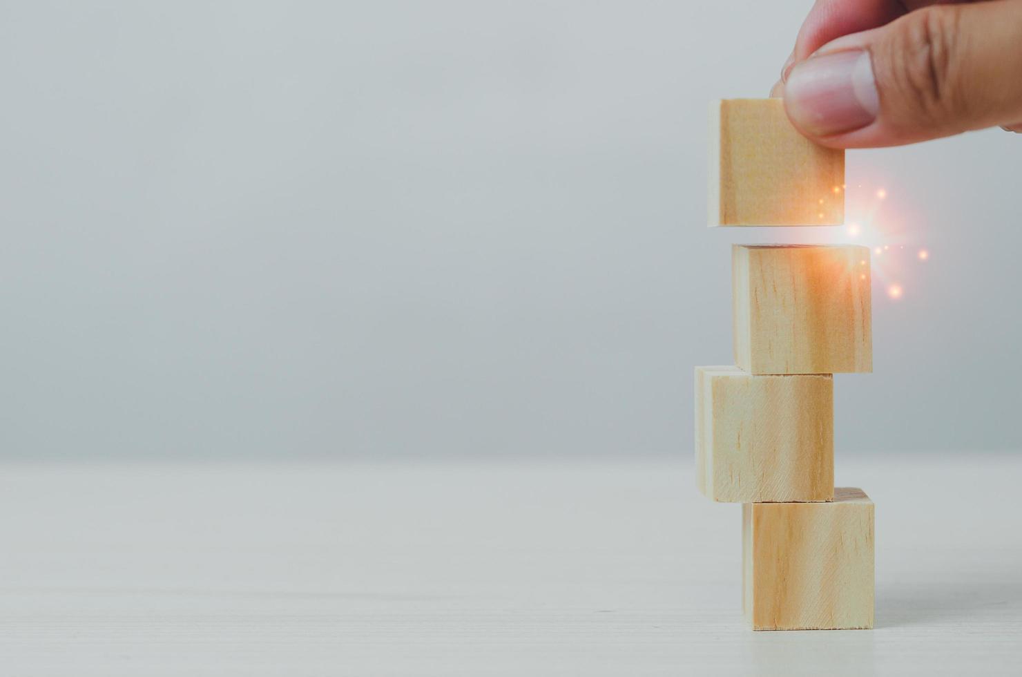 Hand wood block stacking on a table. Business growth Choose a business concept for development and success. Copy space photo