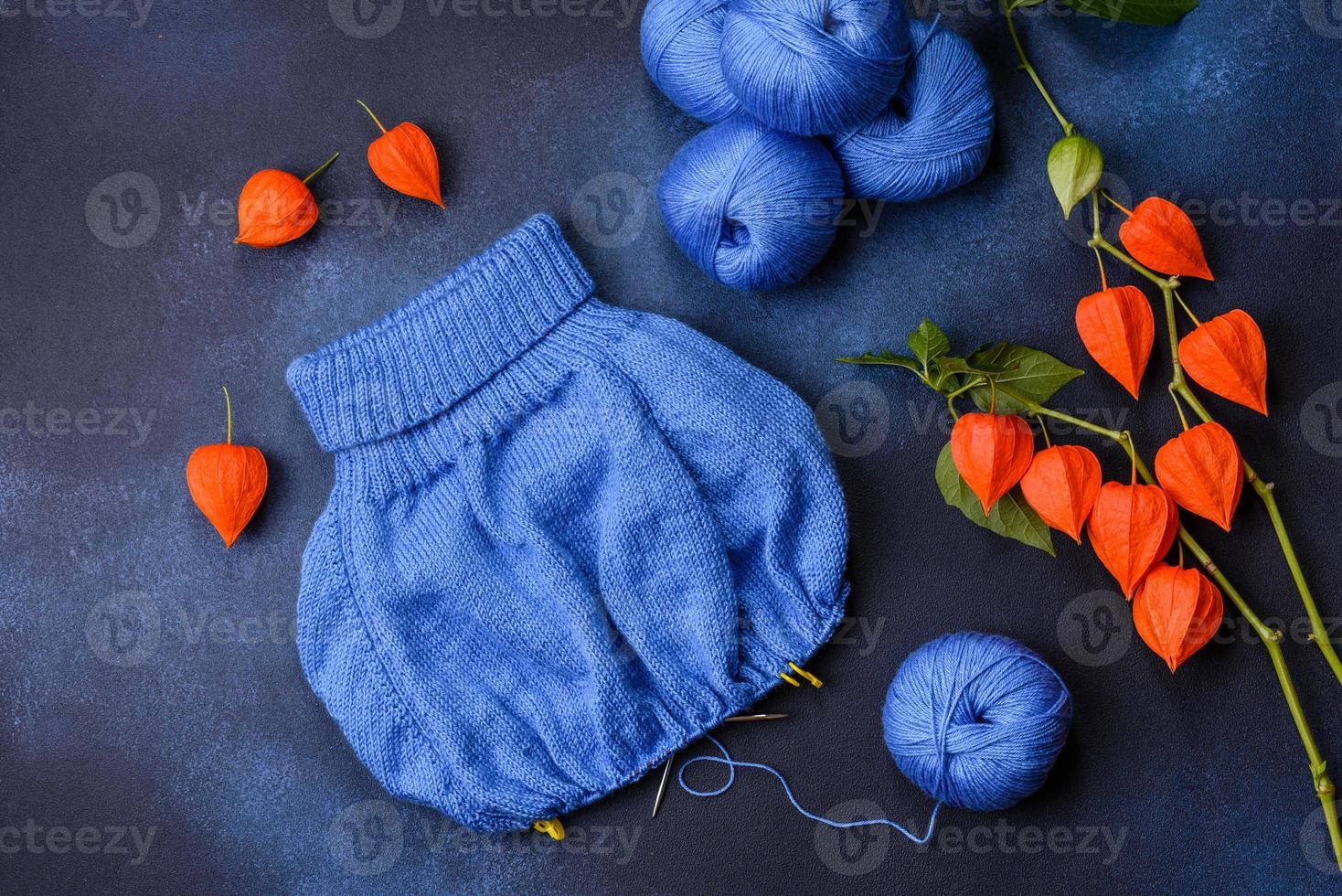 Children's blouse tied with their own hands from blue woolen threads photo