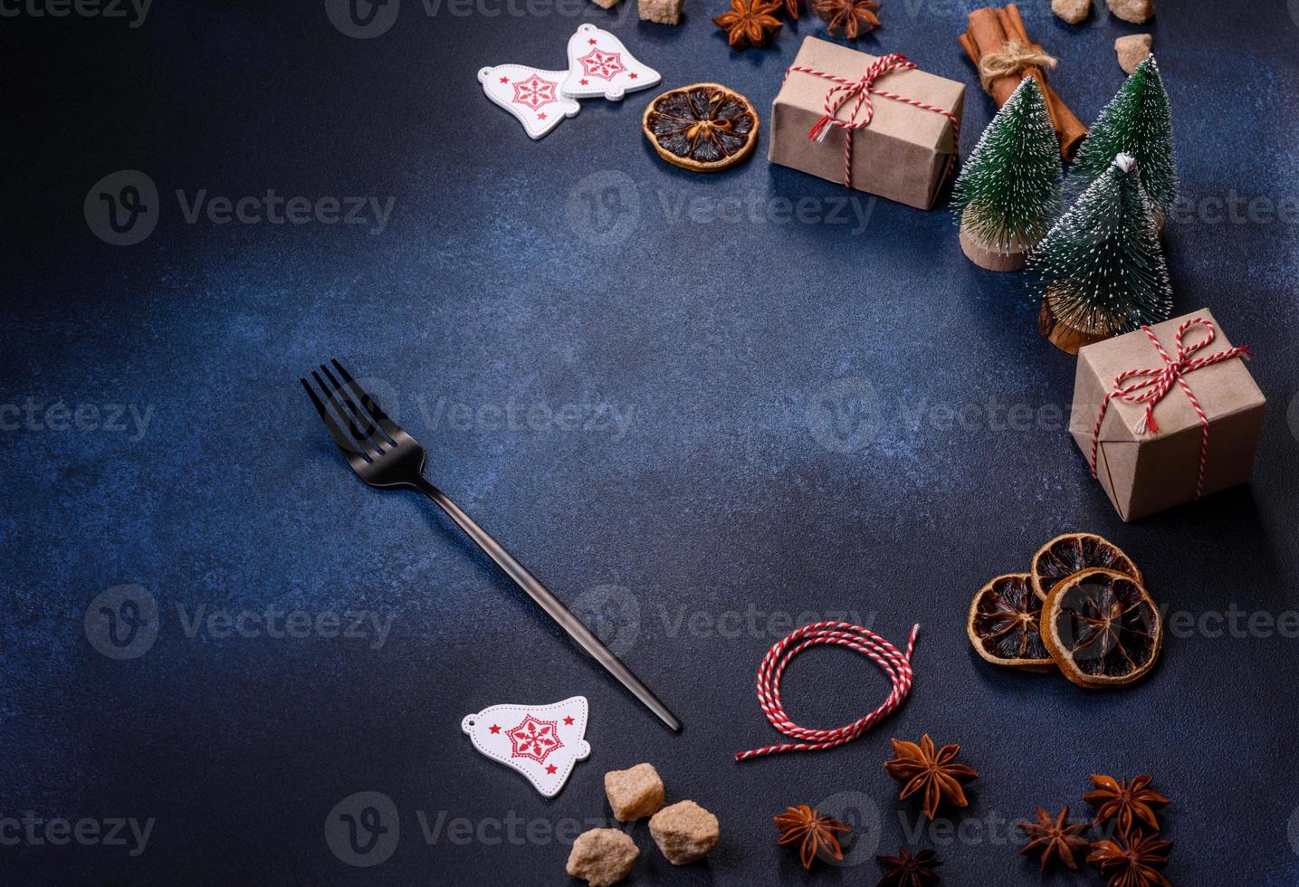 Christmas decorations and gingerbreads on a dark concrete table. Preparing and decorating the house for holiday photo