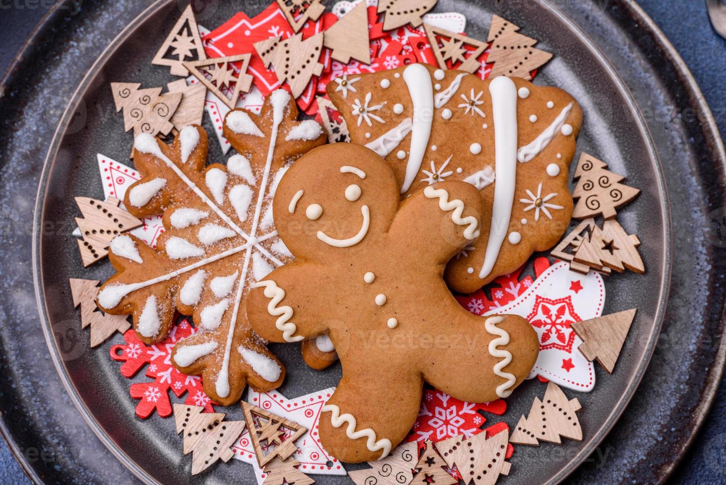 Christmas decorations and gingerbreads on a dark concrete table. Preparing and decorating the house for holiday photo