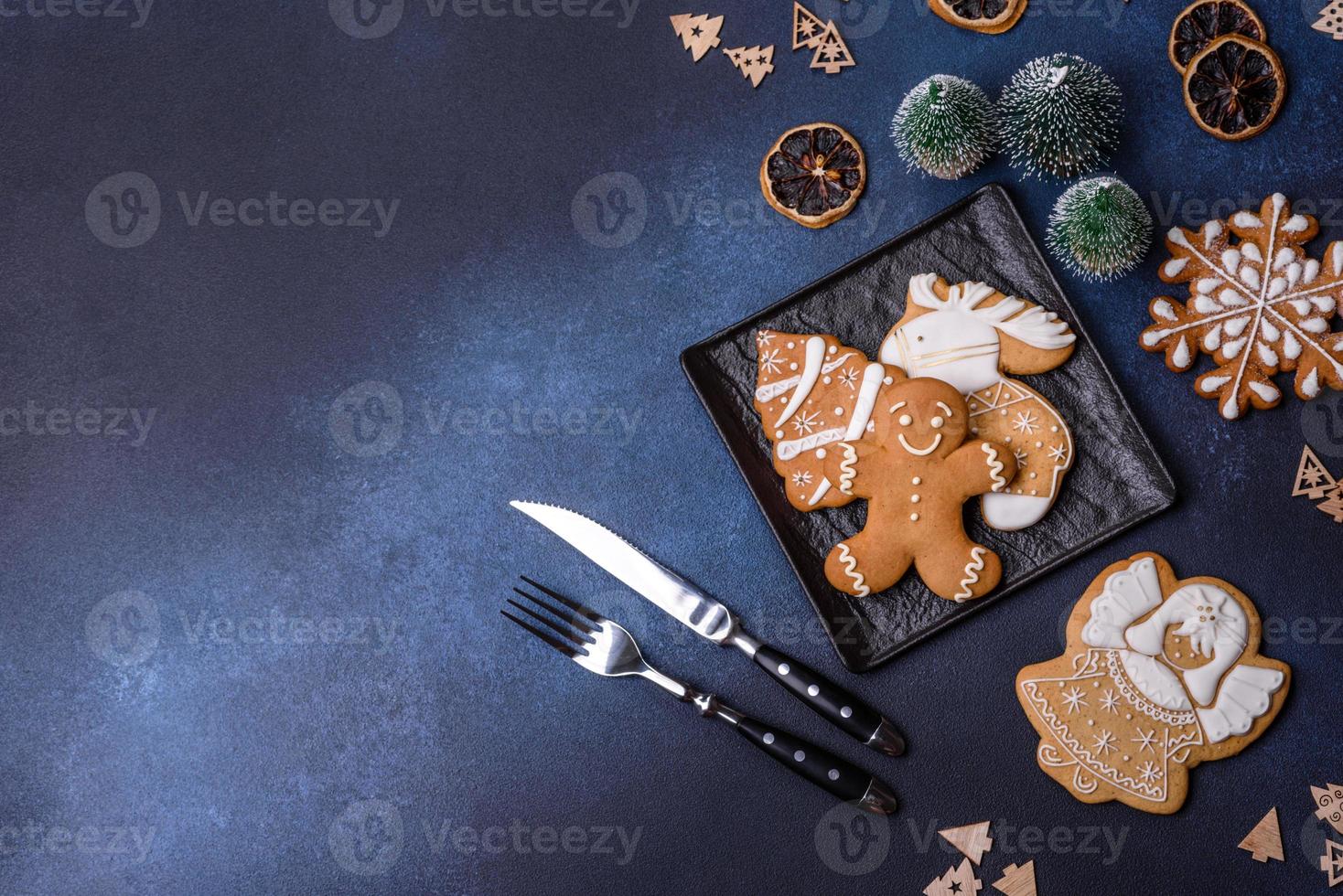 Christmas decorations and gingerbreads on a dark concrete table. Getting ready to celebration photo