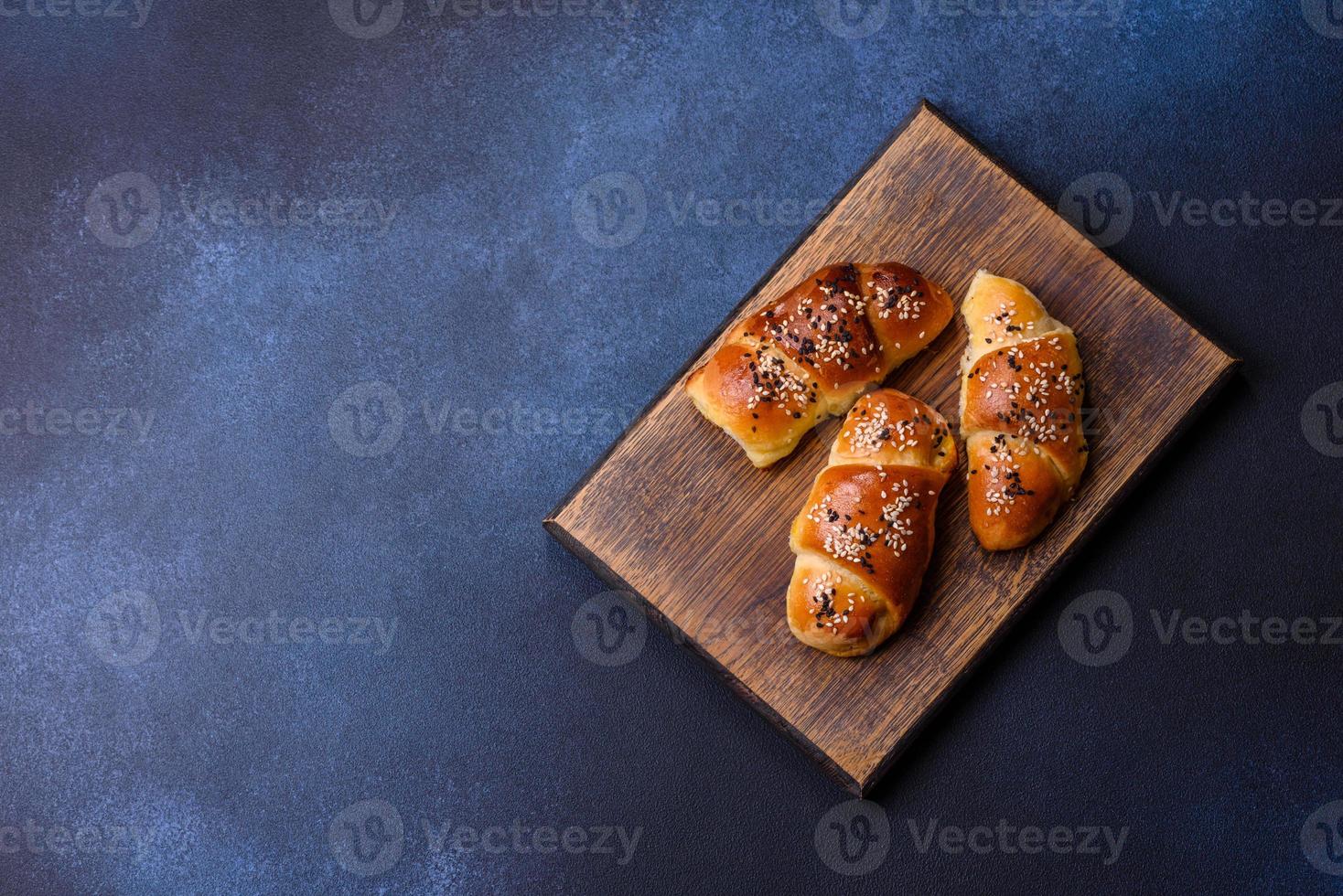Delicious homemade pastries with apricot jam sprinkled with sesame seeds photo