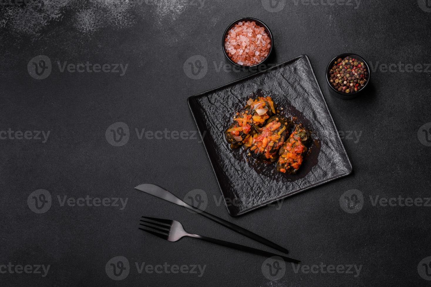 Dolma, stuffed grape leaves with rice and meat on a dark background photo