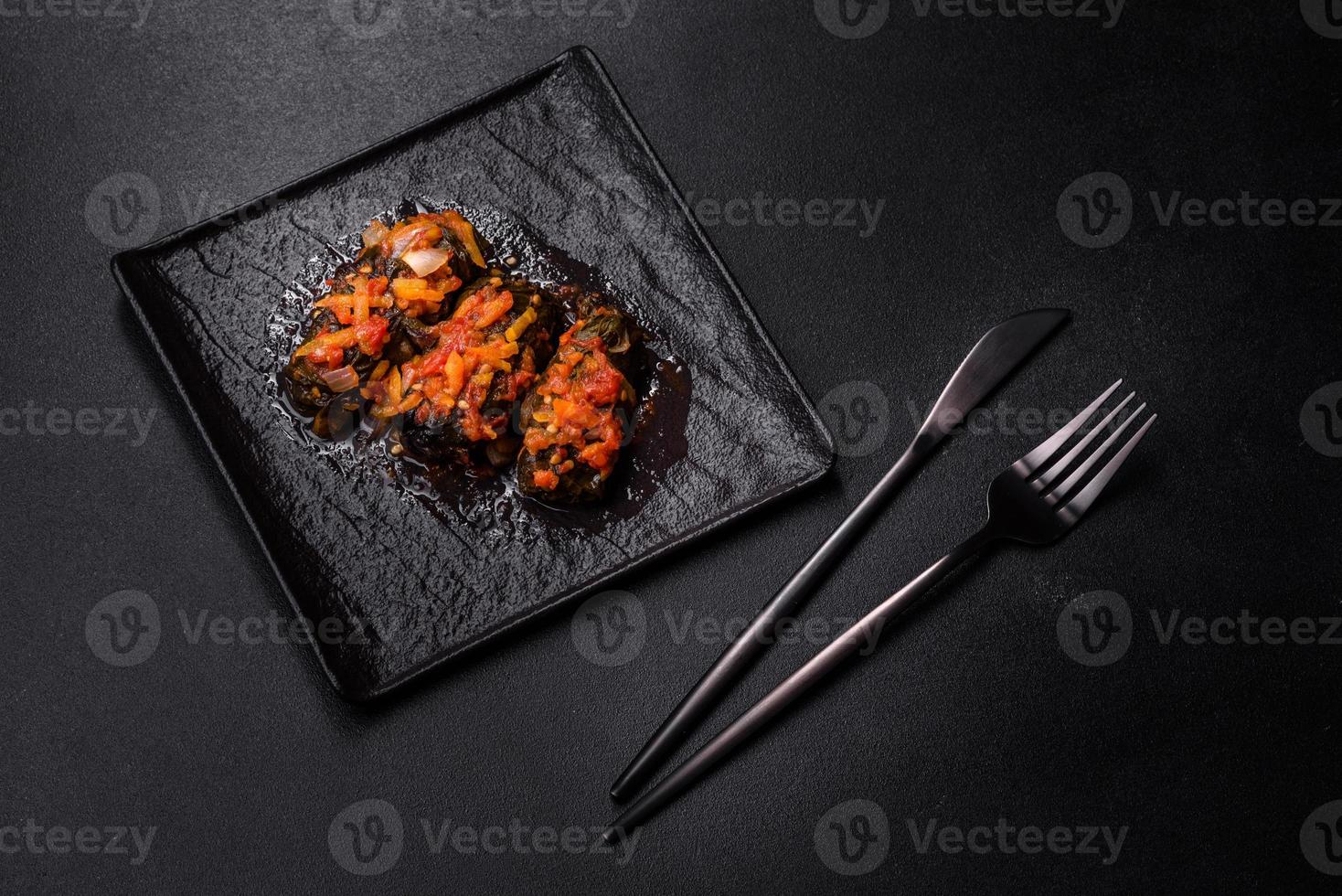 Dolma, stuffed grape leaves with rice and meat on a dark background photo