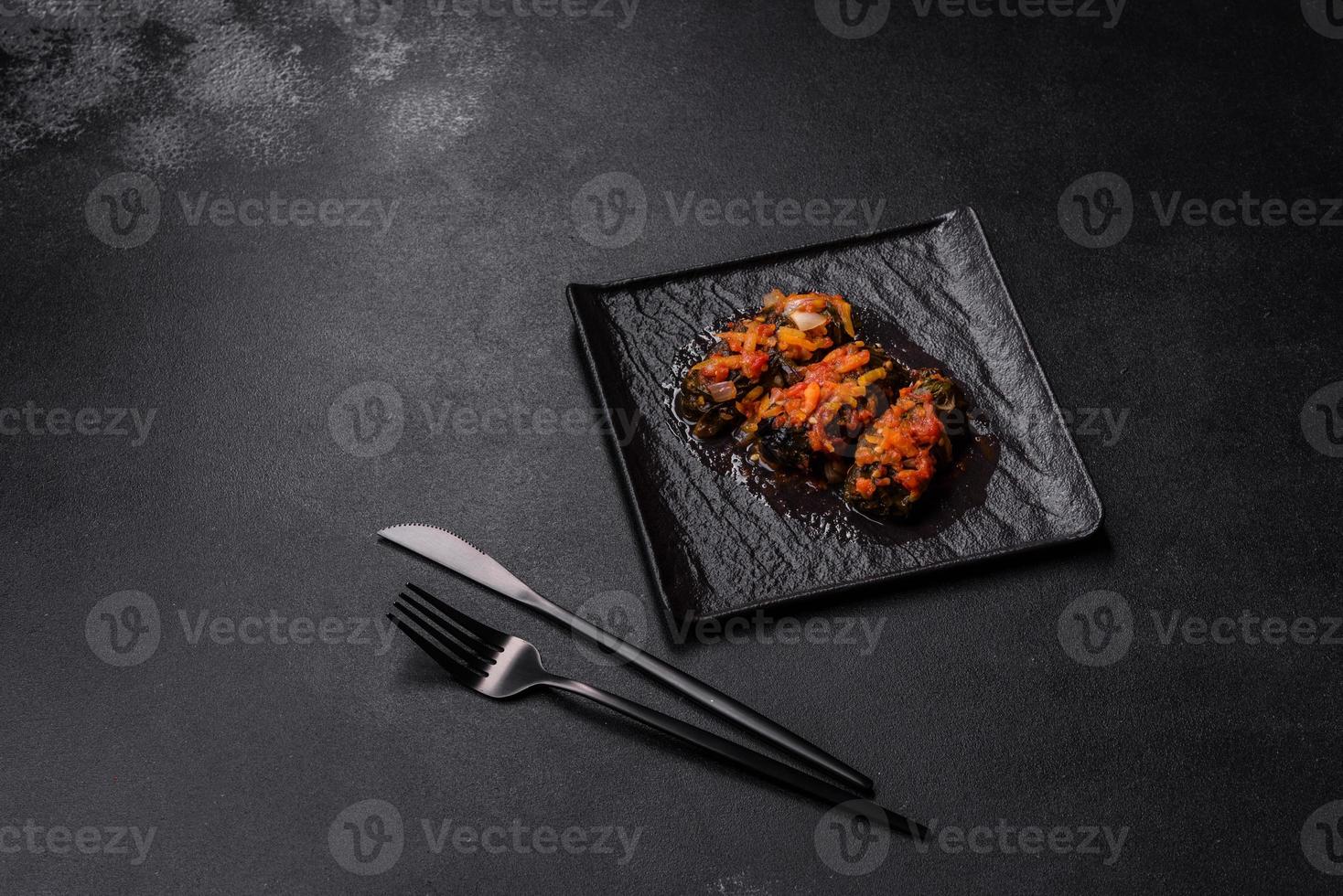 Dolma, stuffed grape leaves with rice and meat on a dark background photo
