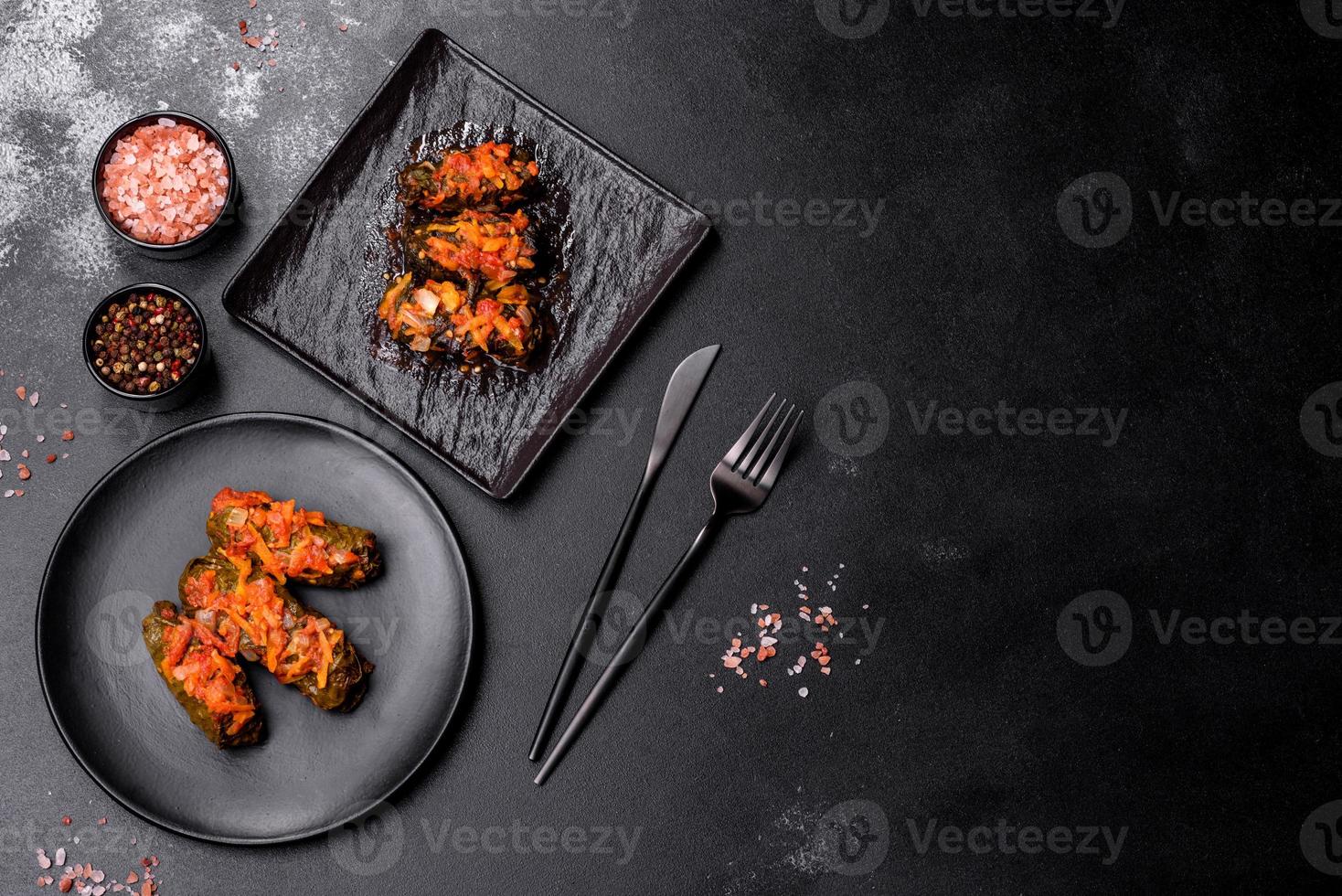 Dolma, stuffed grape leaves with rice and meat on a dark background photo
