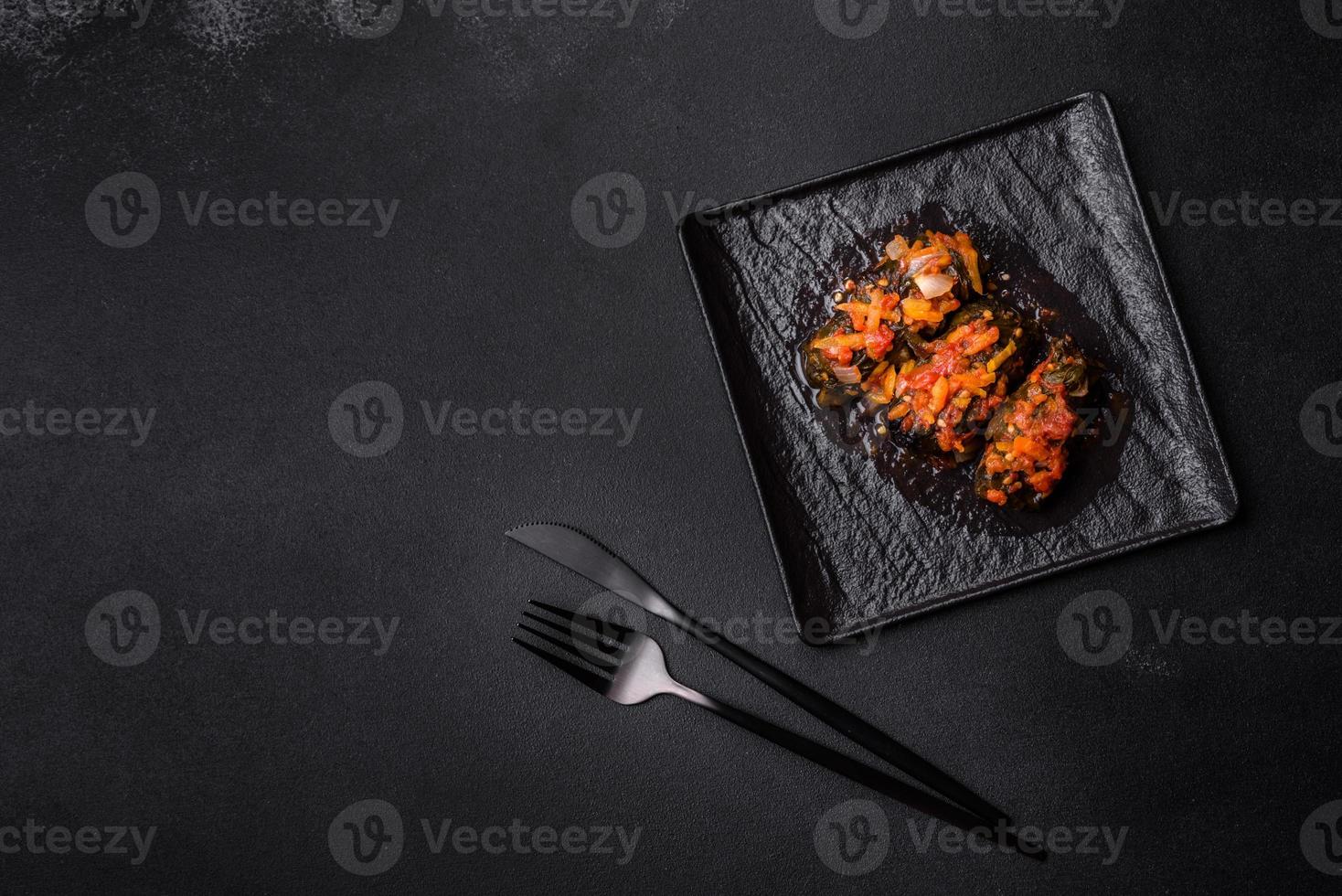Dolma, stuffed grape leaves with rice and meat on a dark background photo
