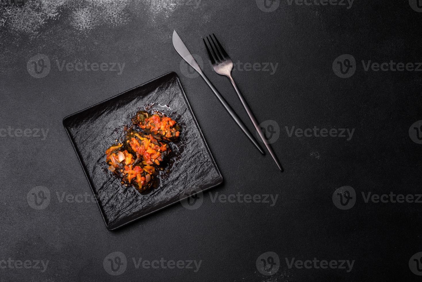 Dolma, stuffed grape leaves with rice and meat on a dark background photo