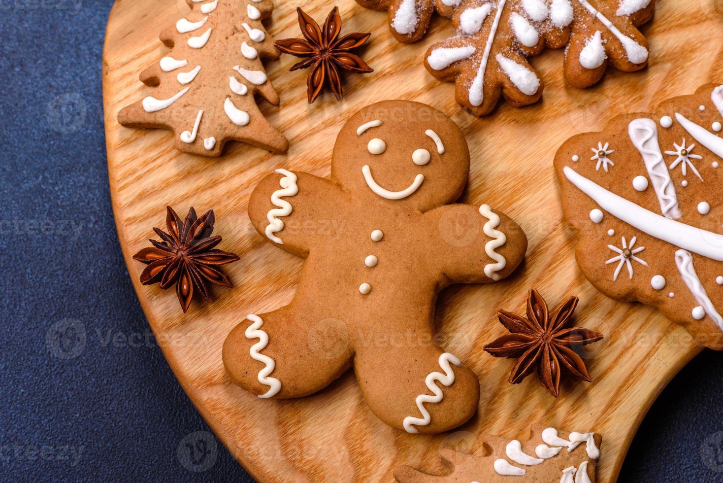 Elements of Christmas decorations, sweets and gingerbread on a wooden cutting board photo
