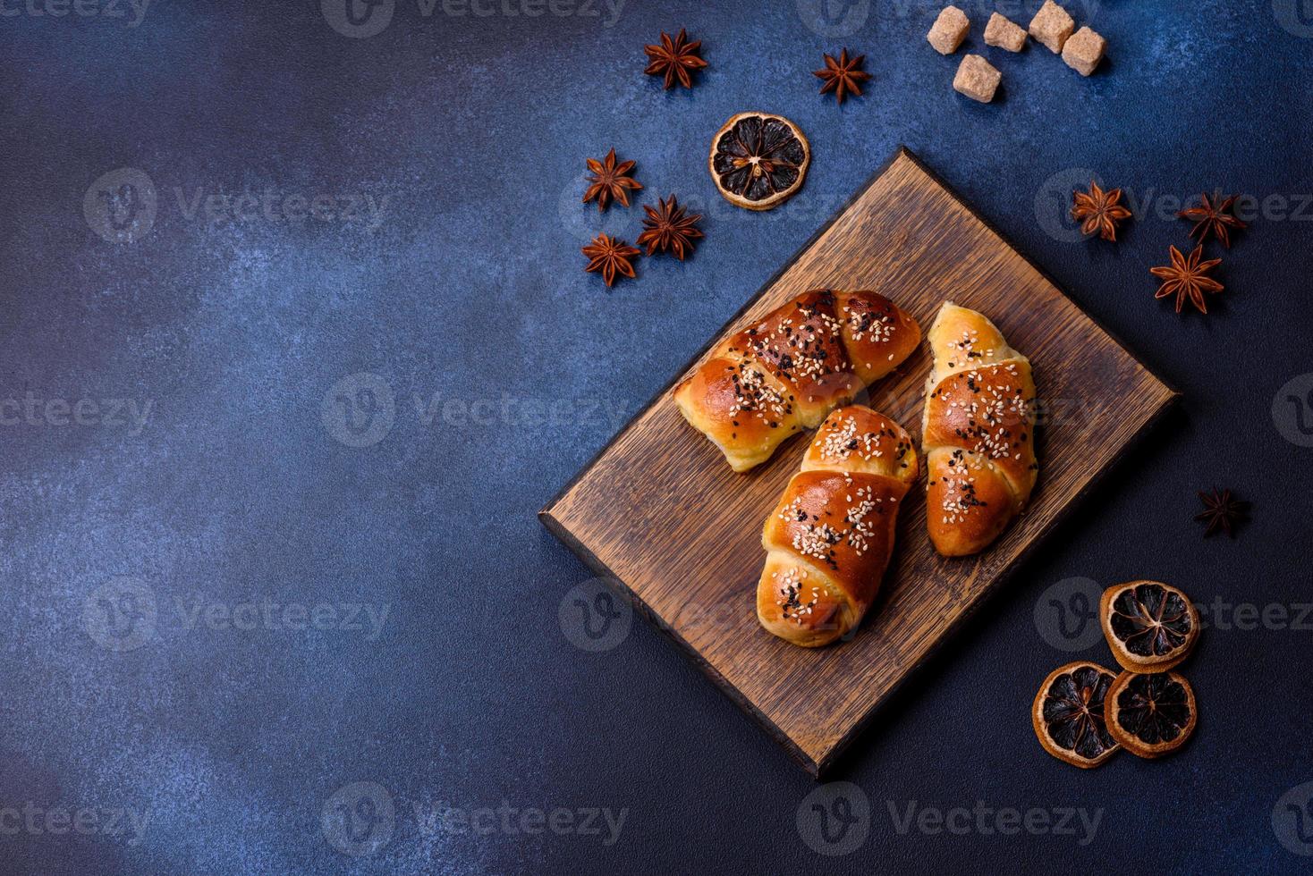 Delicious homemade pastries with apricot jam sprinkled with sesame seeds photo