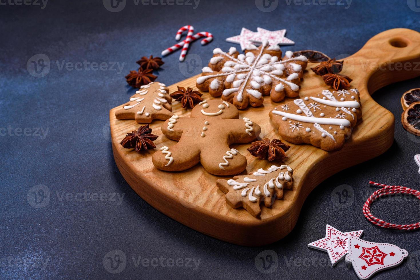 Elements of Christmas decorations, sweets and gingerbread on a wooden cutting board photo