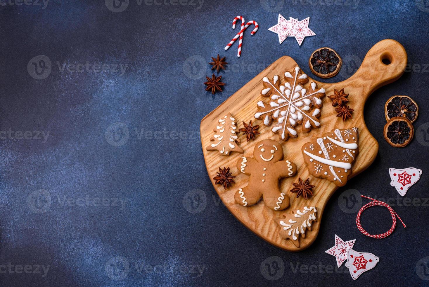 Elements of Christmas decorations, sweets and gingerbread on a wooden cutting board photo