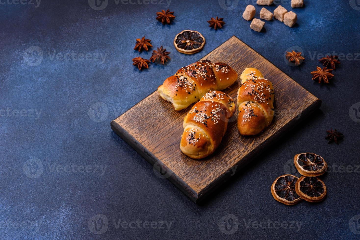 Delicious homemade pastries with apricot jam sprinkled with sesame seeds photo