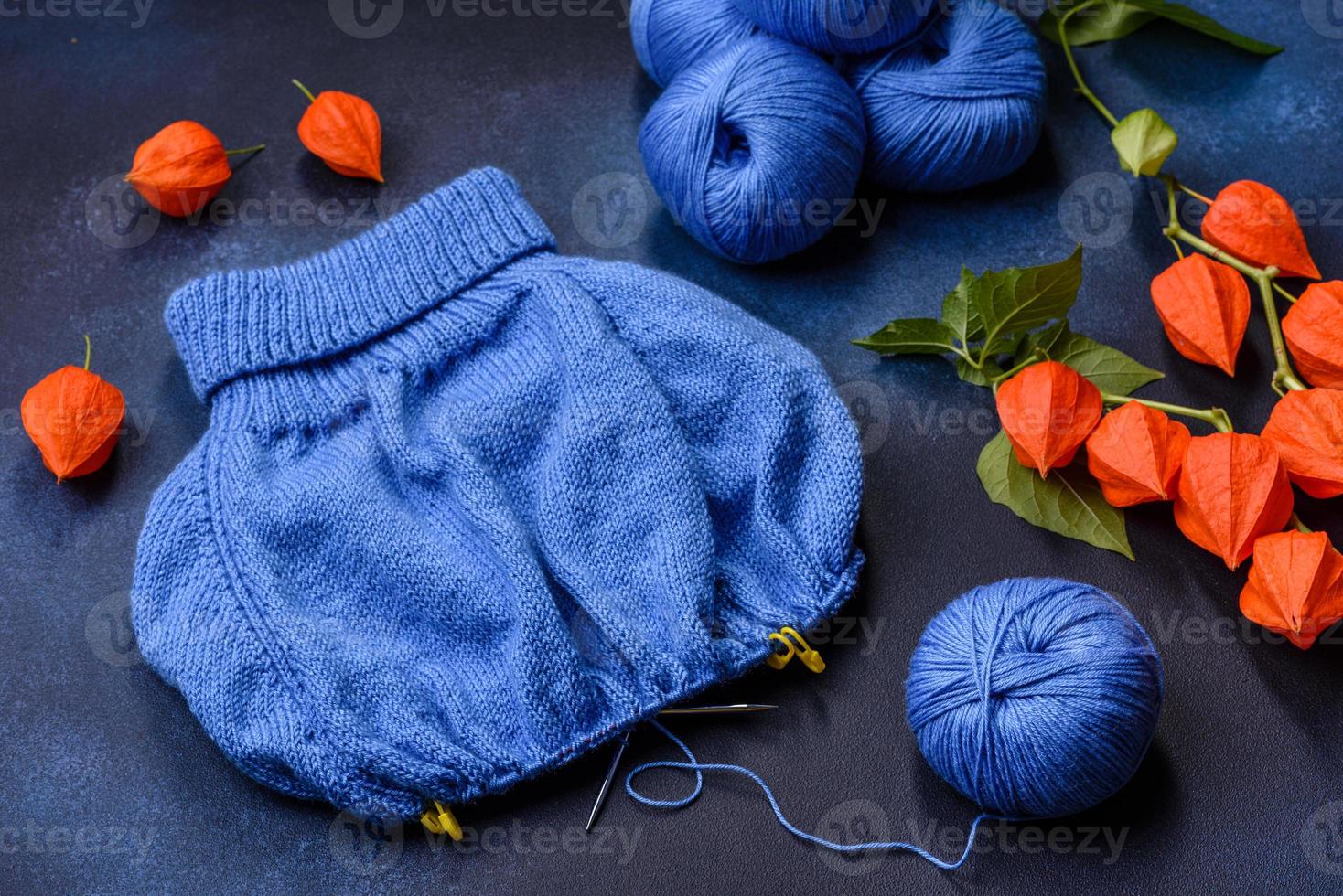 Children's blouse tied with their own hands from blue woolen threads photo