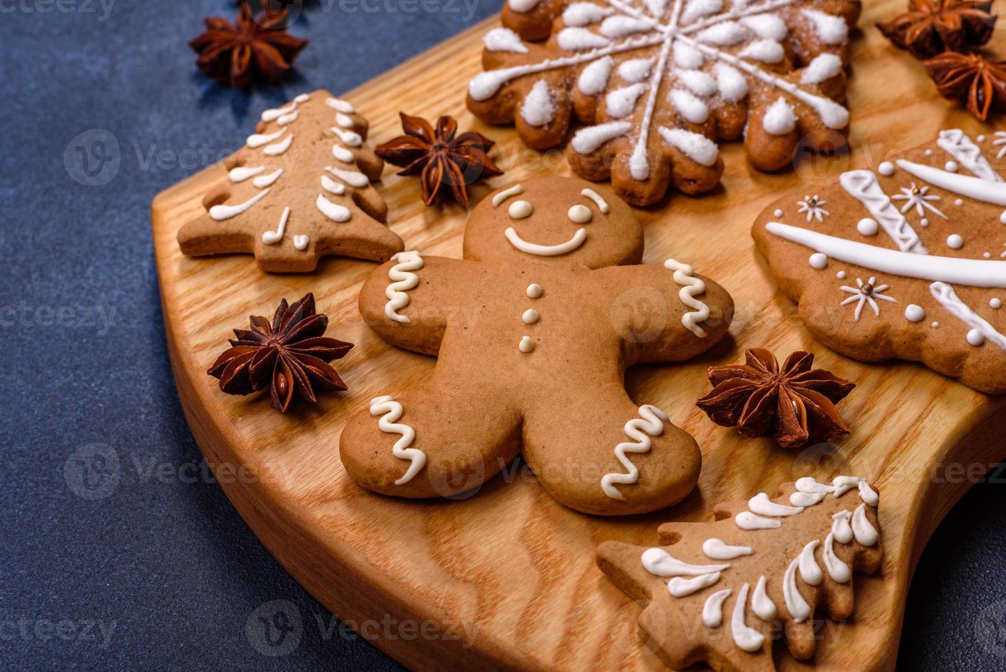 Elements of Christmas decorations, sweets and gingerbread on a wooden cutting board photo