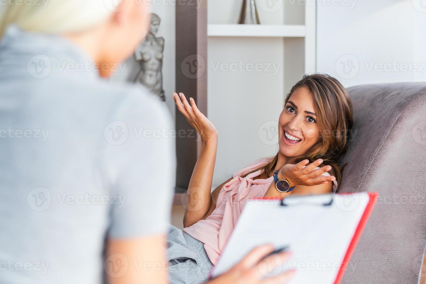 Smiling woman talking to a wellness coach to find motivation to achieve physical health goals. Happy woman talking to a financial expert about a loan for a new apartment. Talking to therapist at home photo