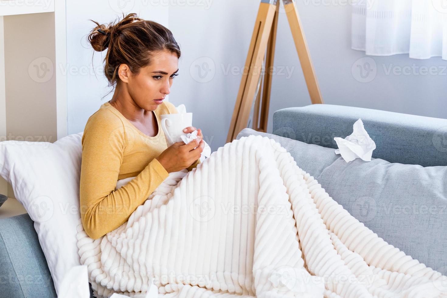 Sick desperate woman has flu. Rhinitis, cold, sickness, allergy concept. Pretty sick woman has runnning nose, rubs nose with handkerchief. Sneezing female. photo