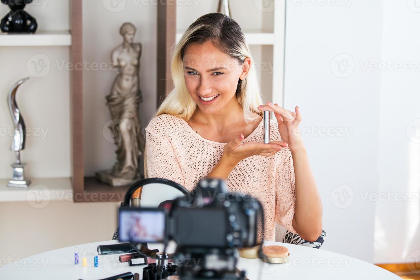 Beautiful young female blogger recording vlog video with makeup cosmetic at home online influencer on social media concept.live streaming viral photo