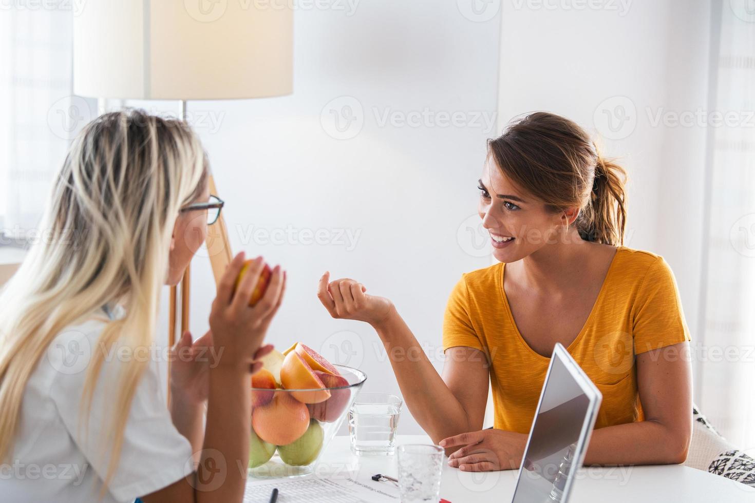 Professional nutritionist meeting a patient in the office and healthy fruits with tape measure, healthy eating and diet concept. Nutritionist desk with healthy fruit, juice and measuring tape. photo