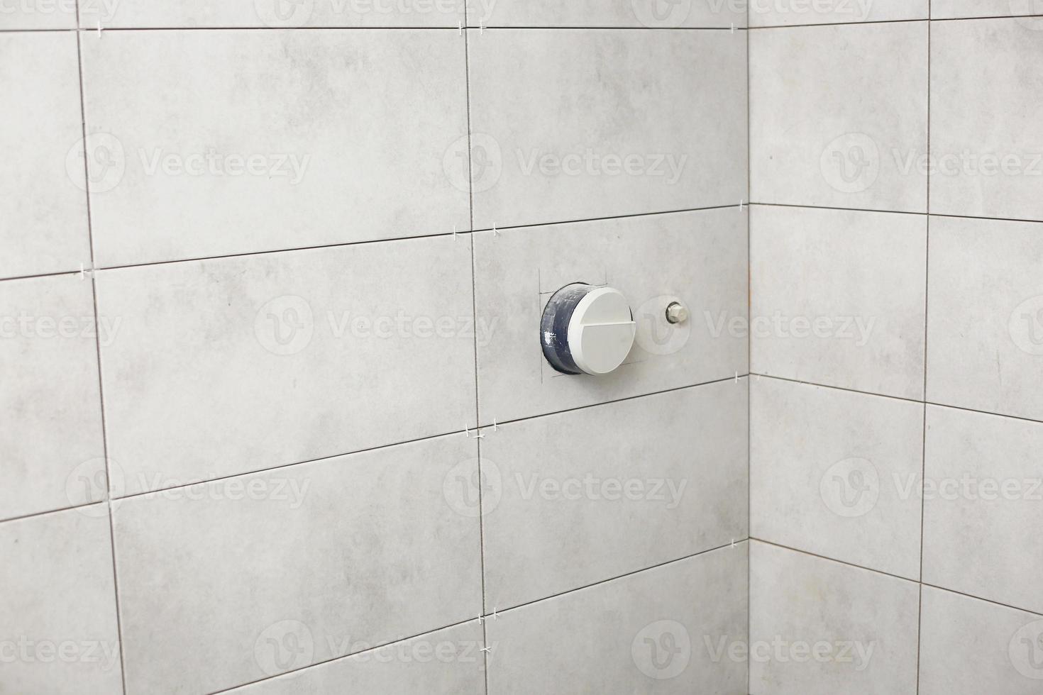 bathroom gray tiles with neat rectangular patterns and built-in shower. Bathroom Tiles Texture. repair photo
