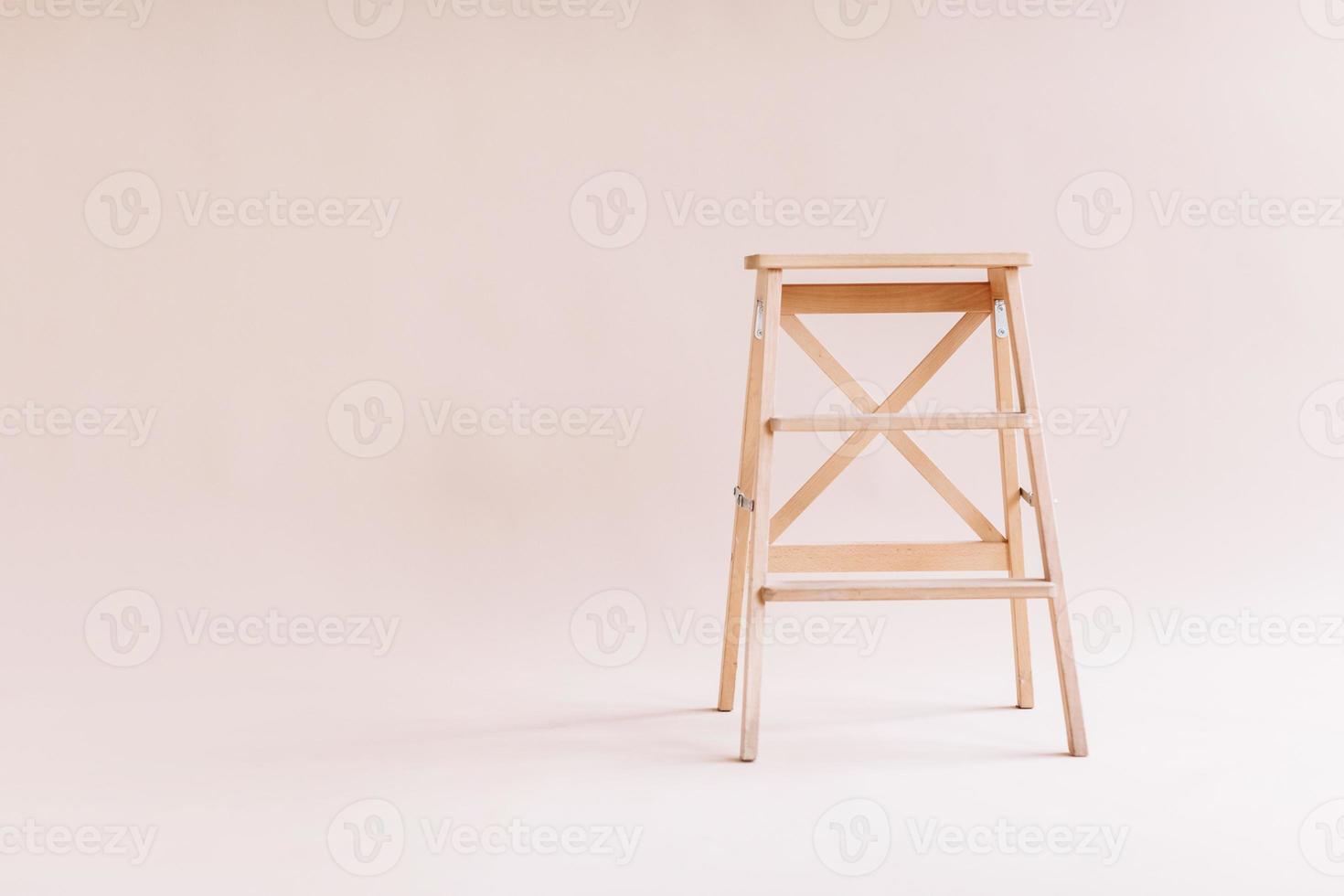 New wooden ladder on the white background. isolated stepladder. Space for text photo