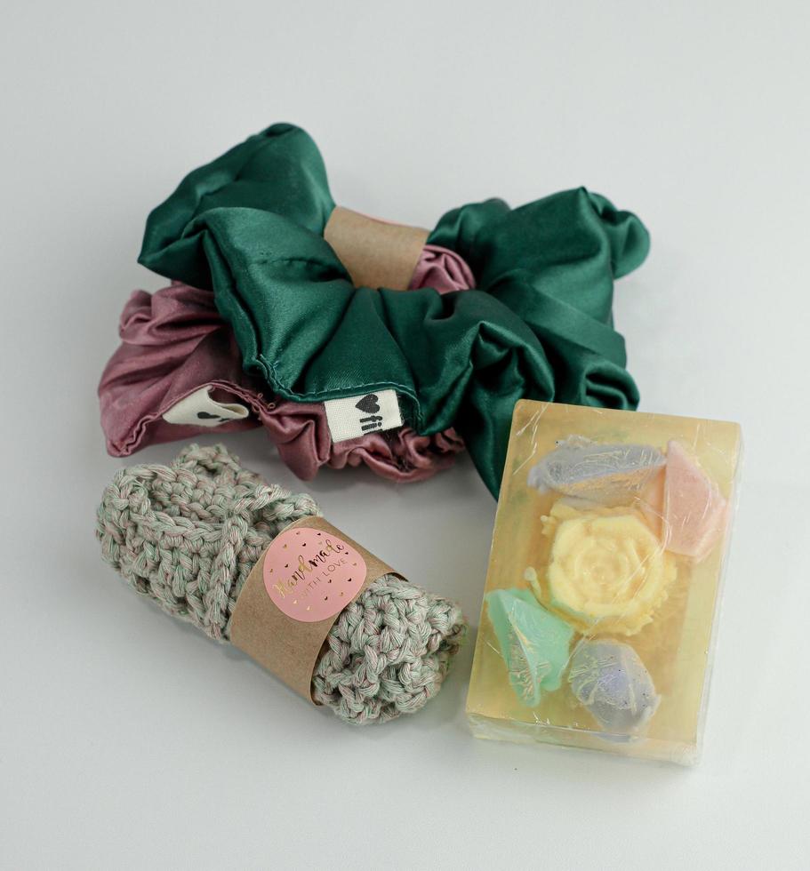 silk pink and green  scrunchies on white backgrounds an flower.Diy accessories and hairstyles concept photo