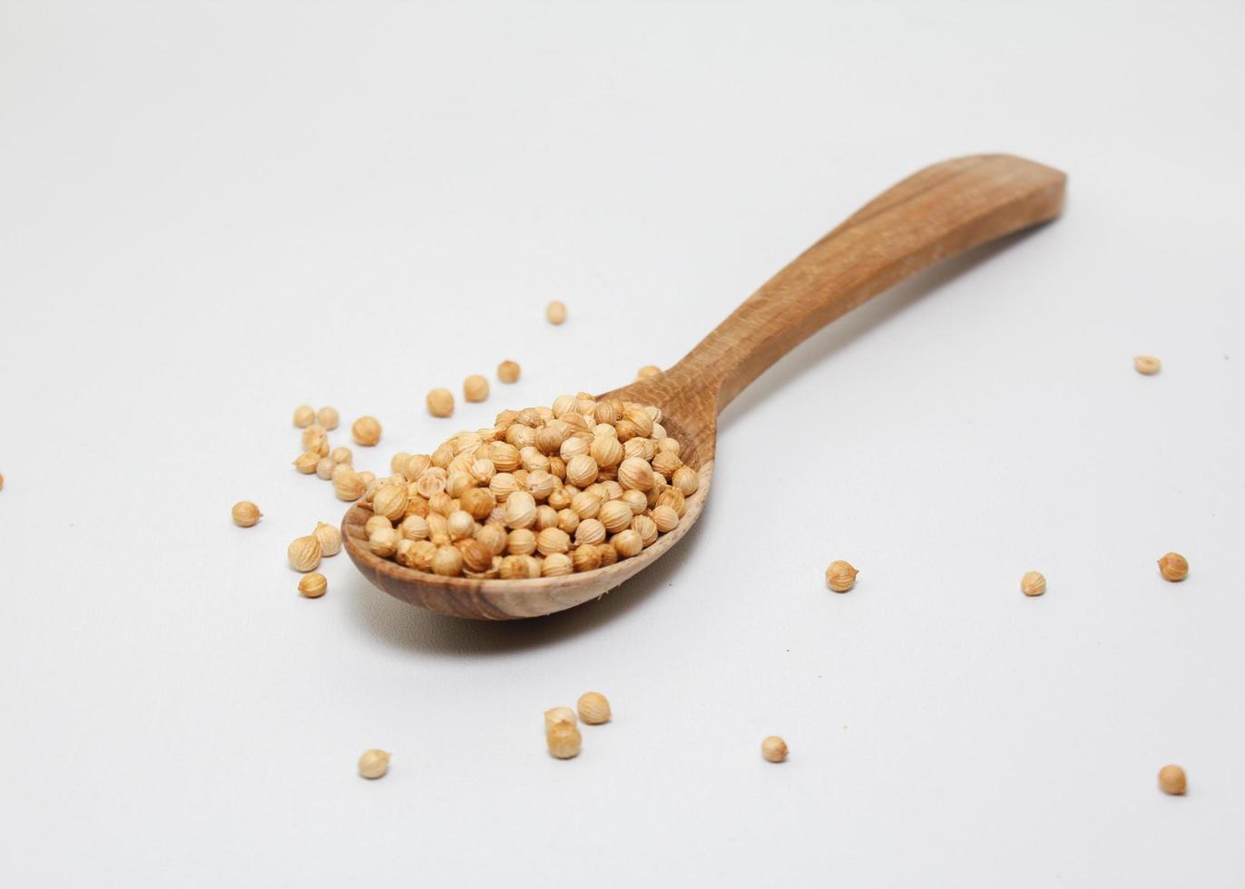 dry coriander seed spice on wood background photo