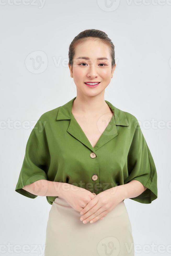 Happy young Asian business woman standing isolated over white background photo