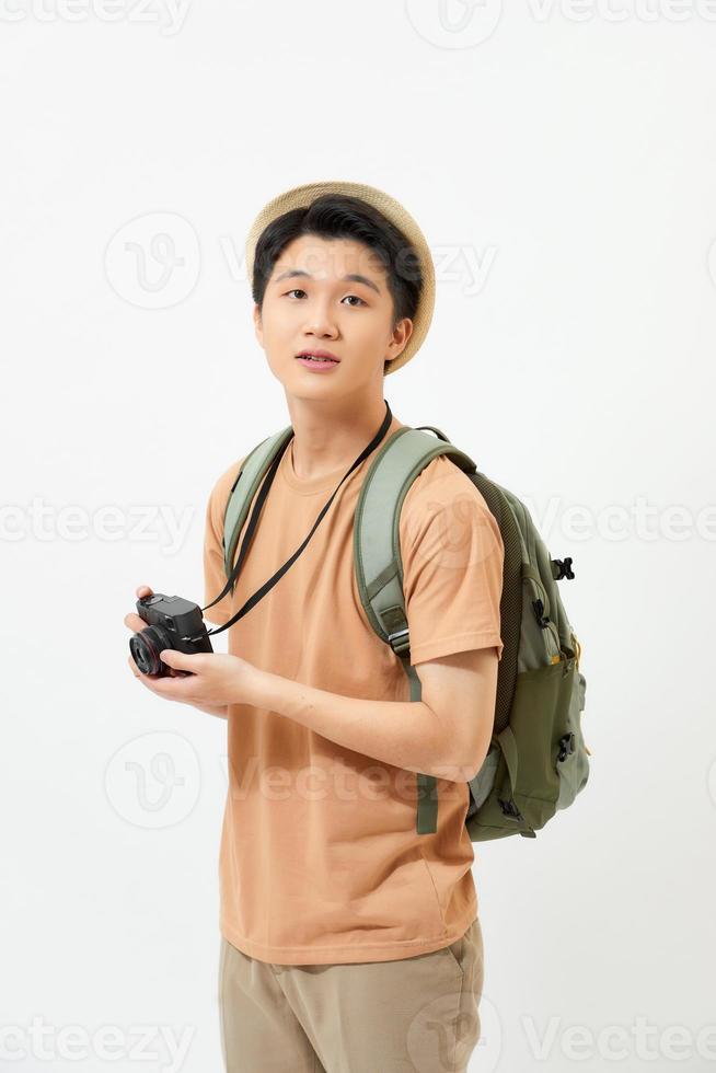 Smiling traveler tourist man in yellow summer clothes with photo camera isolated