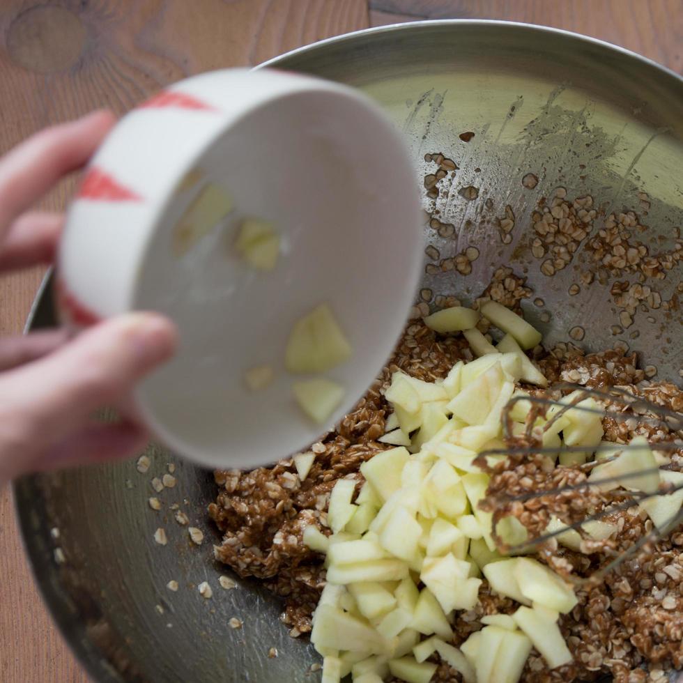 Unrecognizable person mixing ingredients for healthy cookies photo