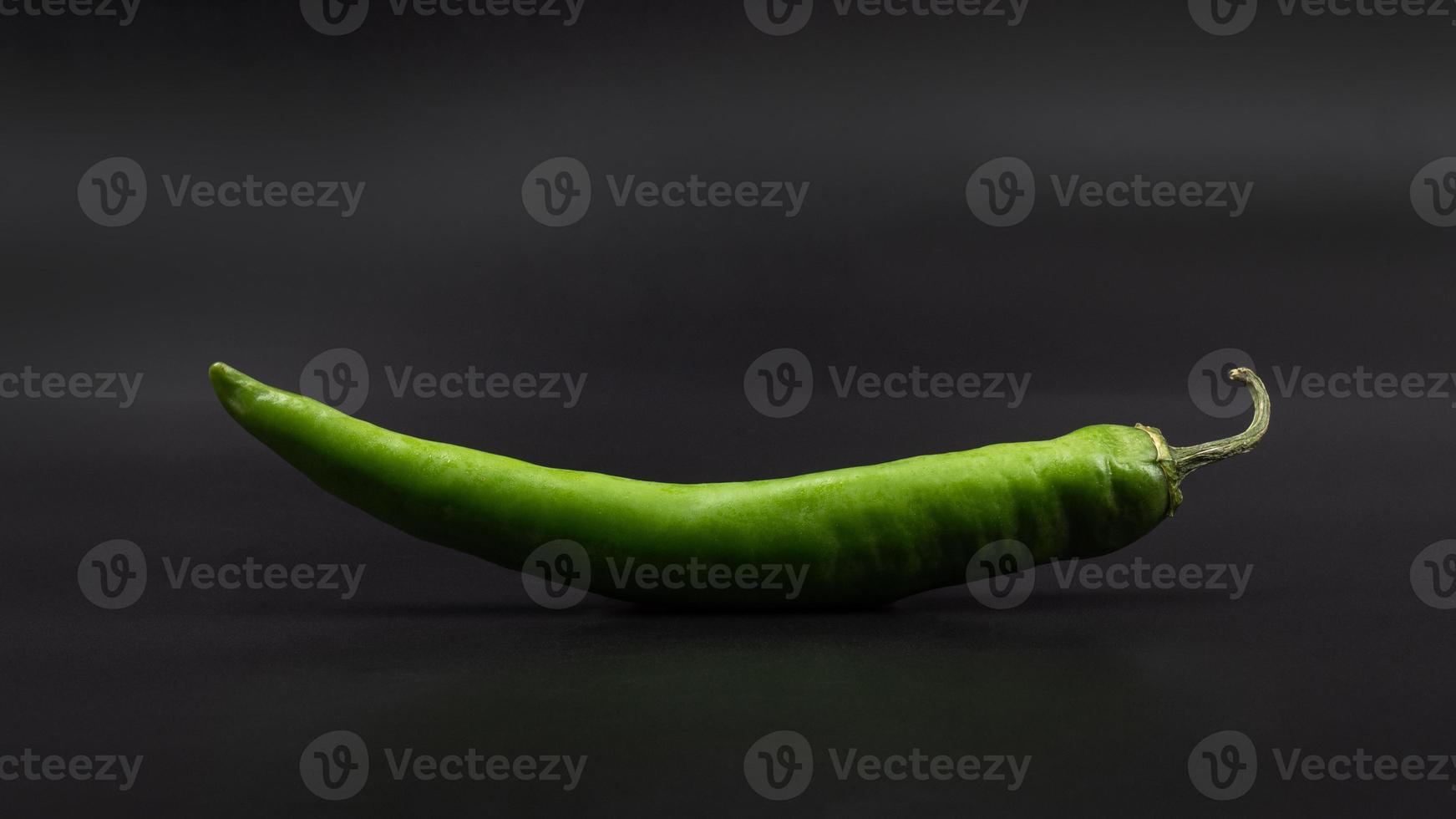 green chili pepper on a gray background photo