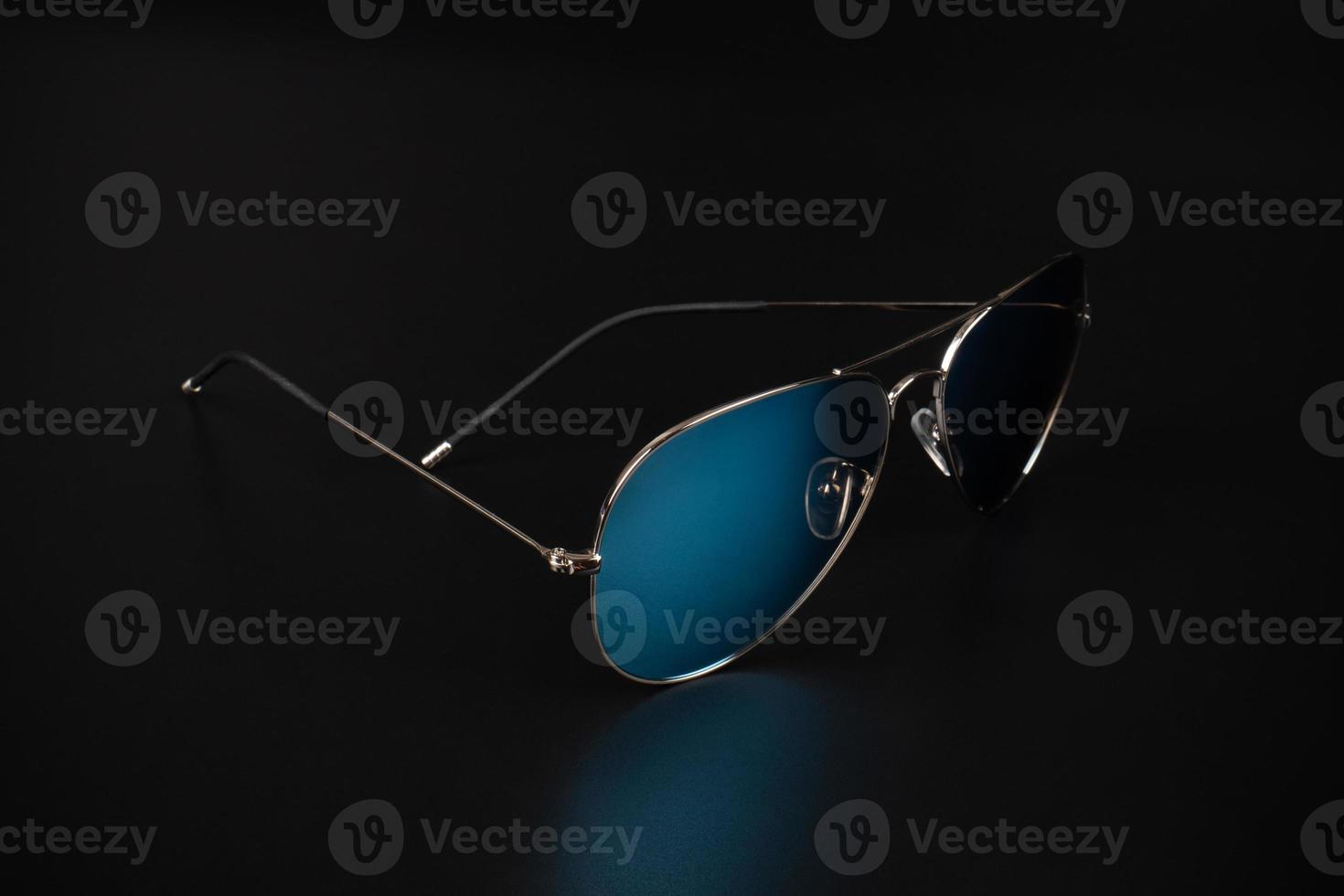 blue polarized sunglasses in dark background photo